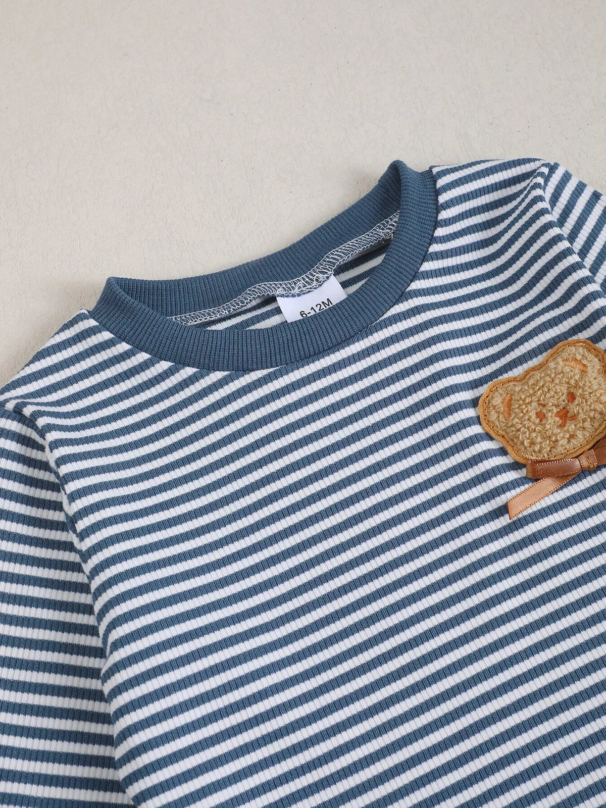 Navy neckline and bear applique