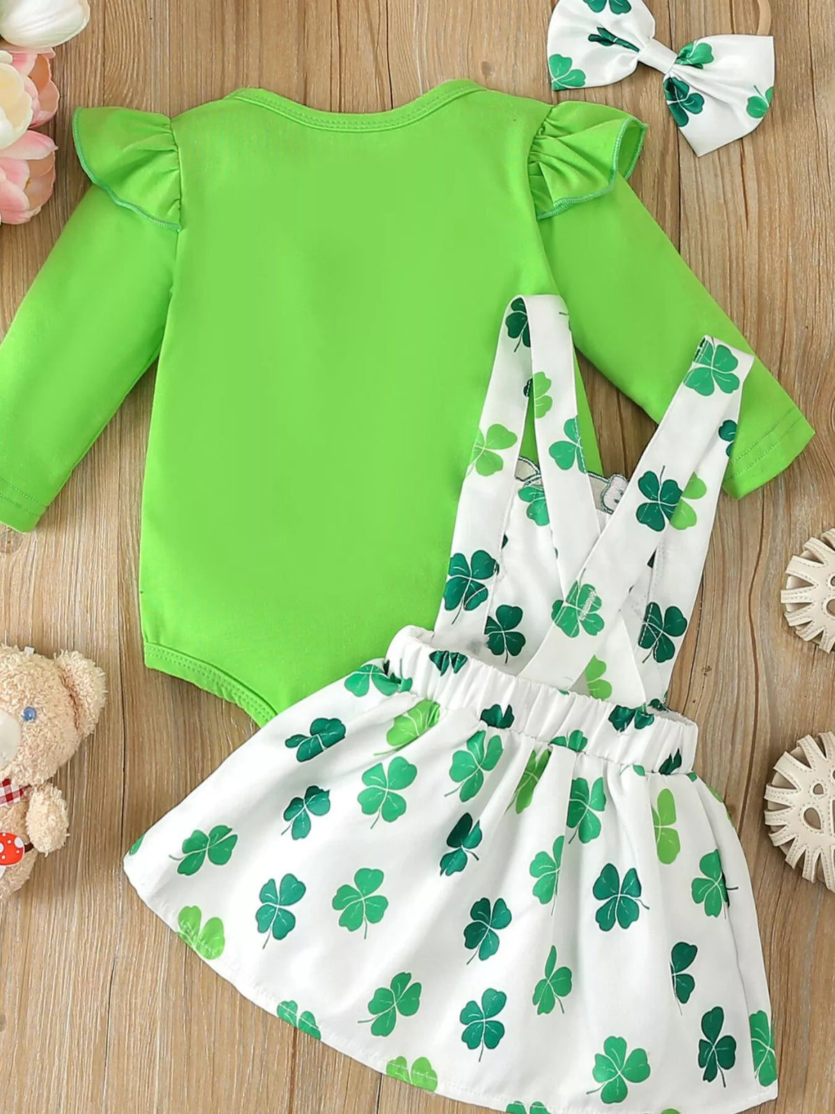Back of the green bodysuit and clover-print overall dress