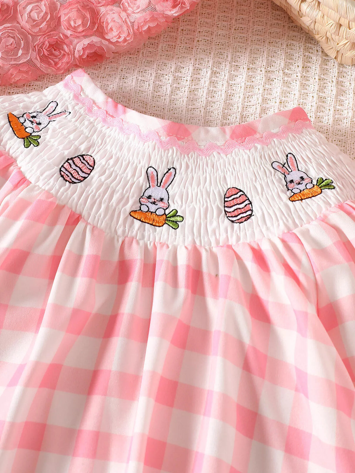 Bunny-and-egg embroidery on the smocked neckline