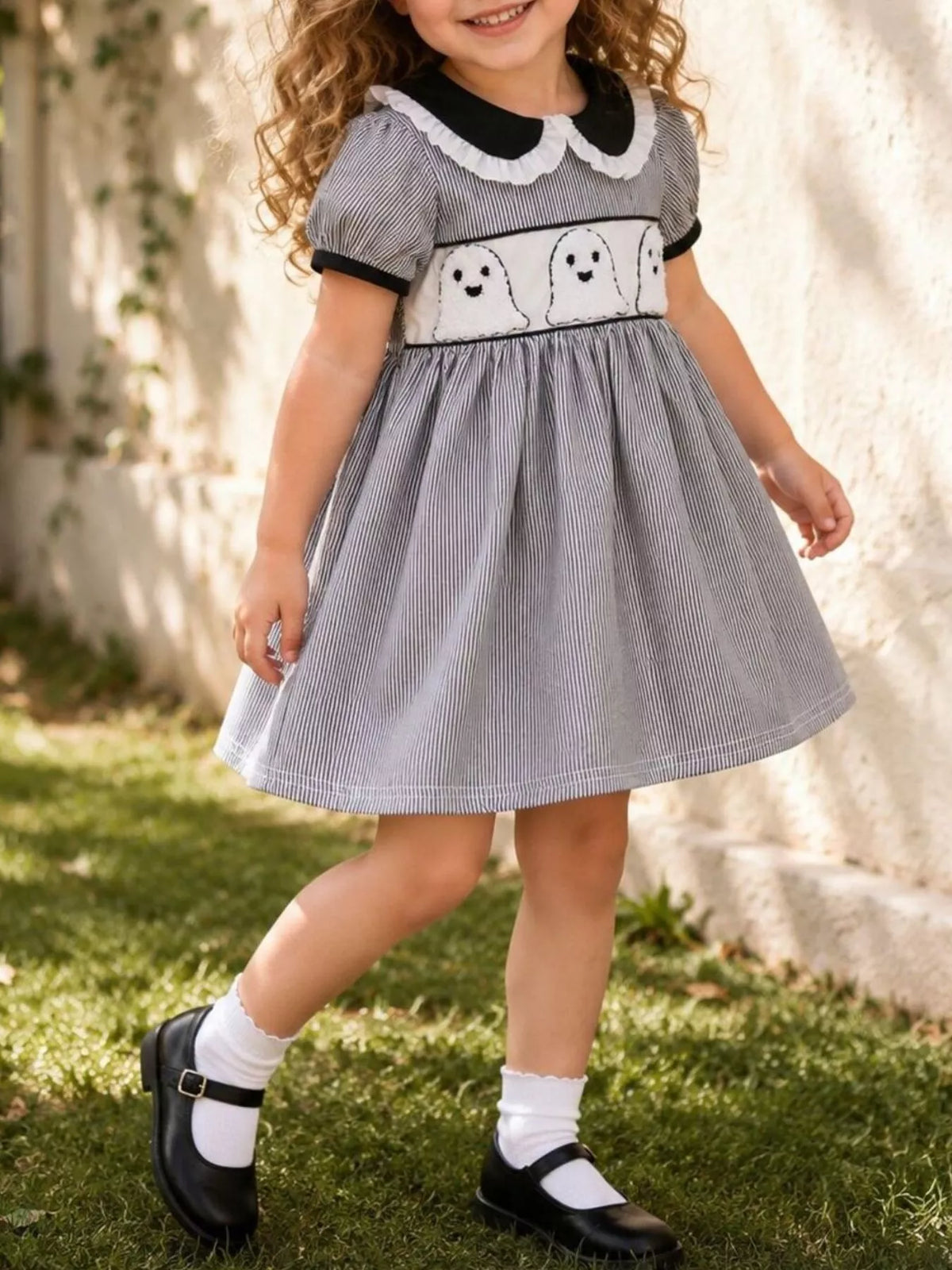Black gingham ghost dress on a child walking