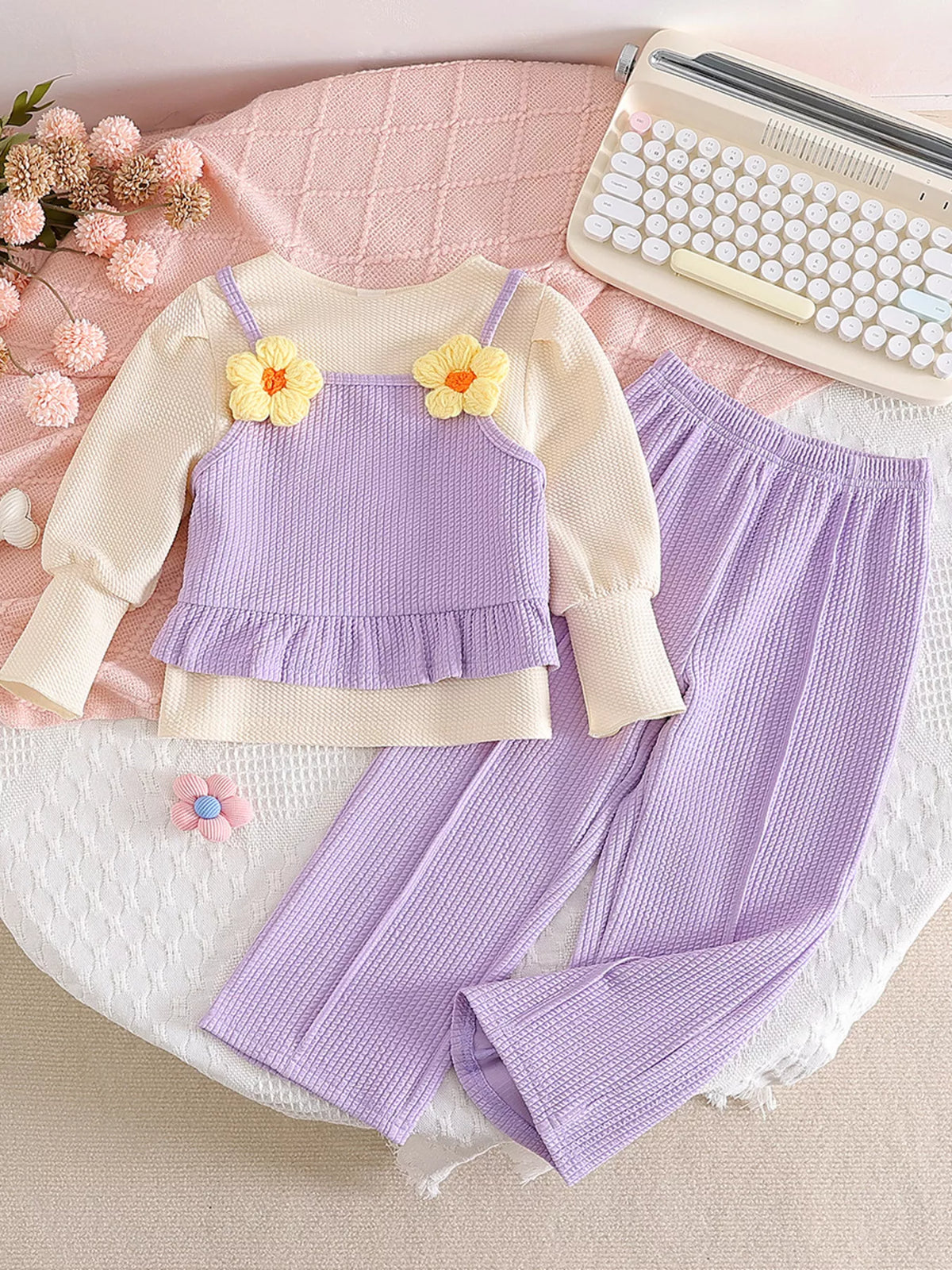 Cream-and-lavender layered-look long-sleeve top with lavender pants laid flat