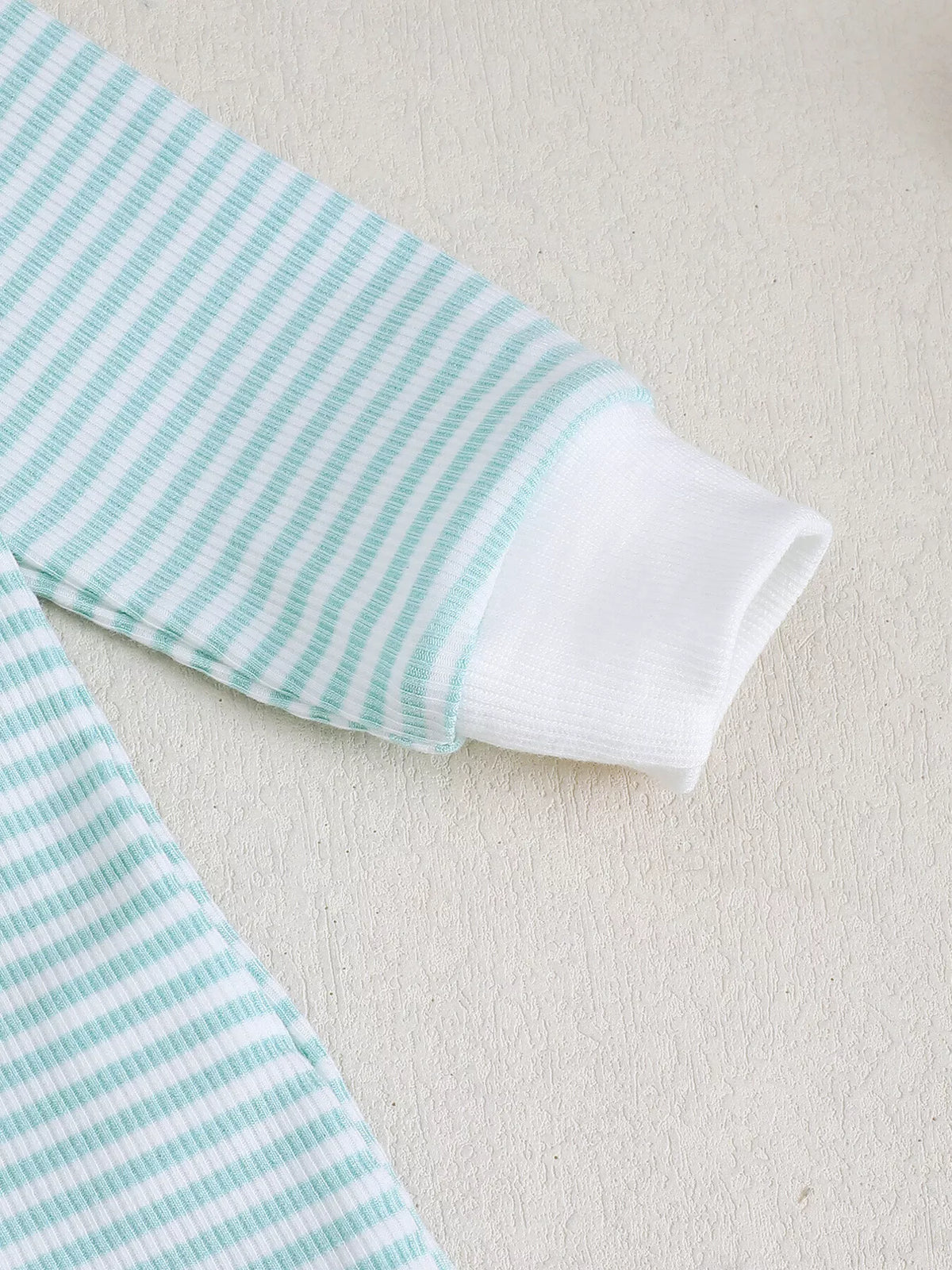 White cuff on a pale blue striped sleeve