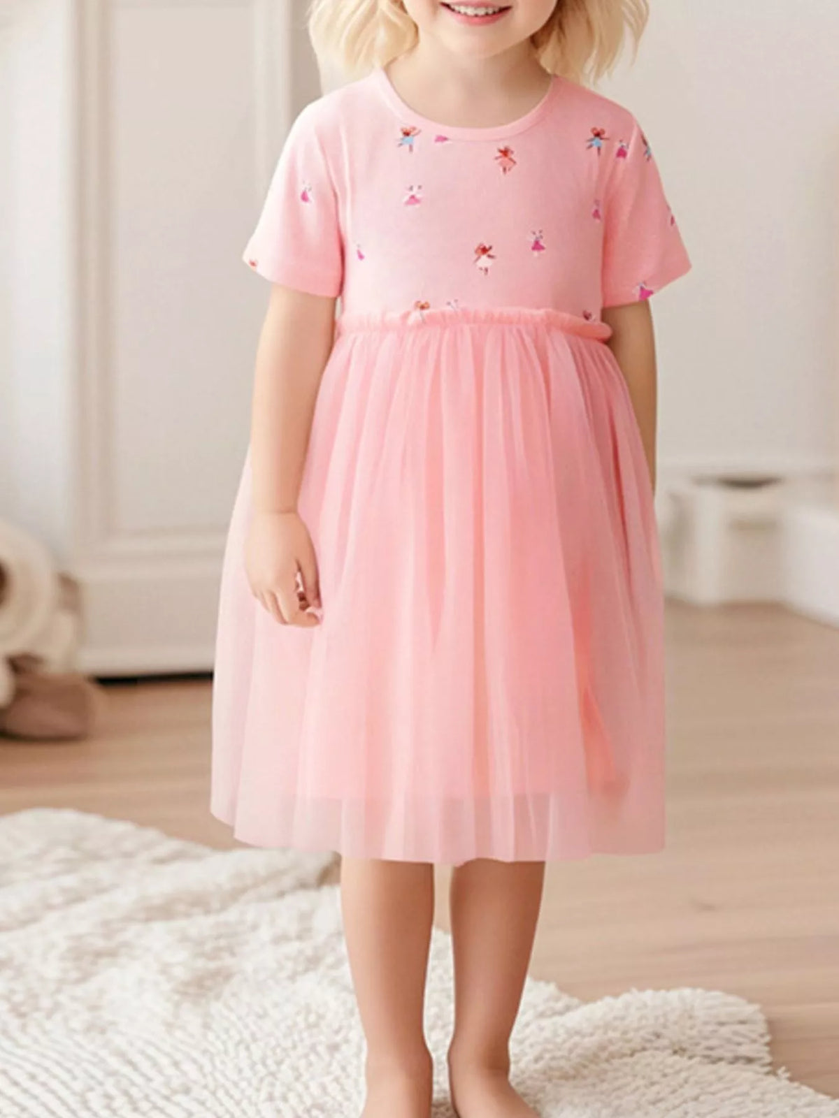 Pink Rainbow Print Tulle Dress — pink dress worn by a child