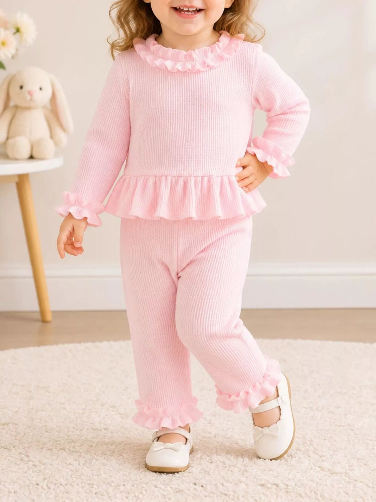 Pink ruffle-trimmed outfit on a child