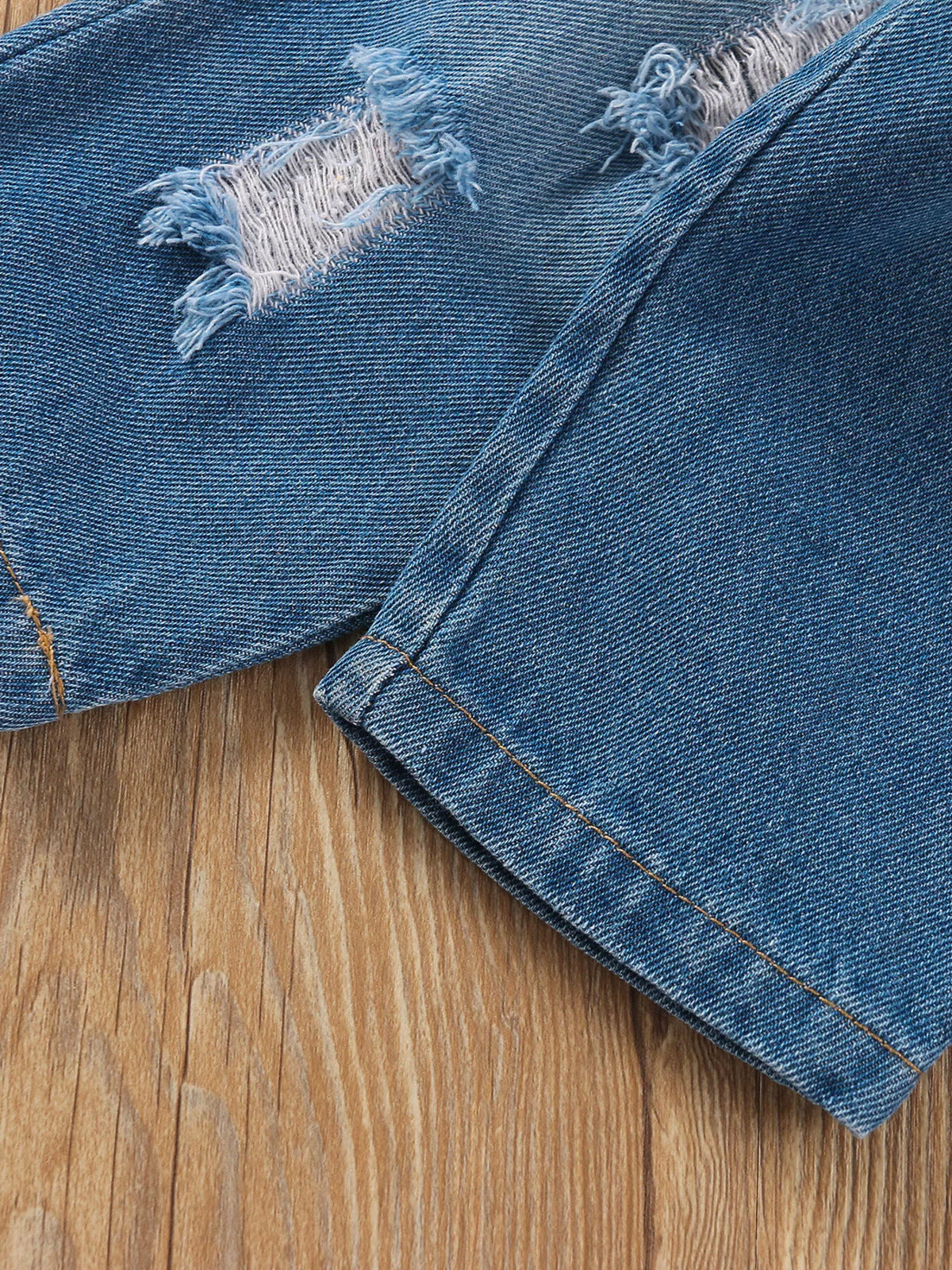 Distressed denim patches and stitched leg hem