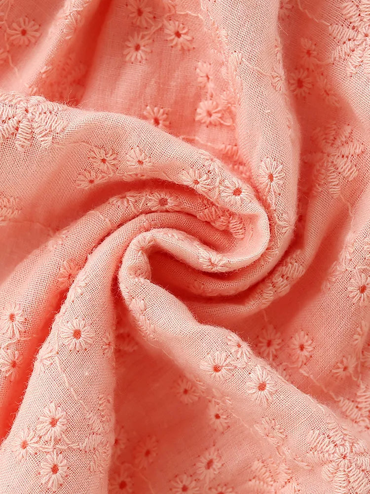 Peach eyelet fabric close-up