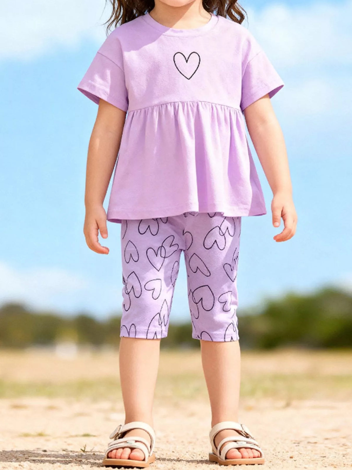 Lavender heart peplum tee with heart-print fitted shorts on a child