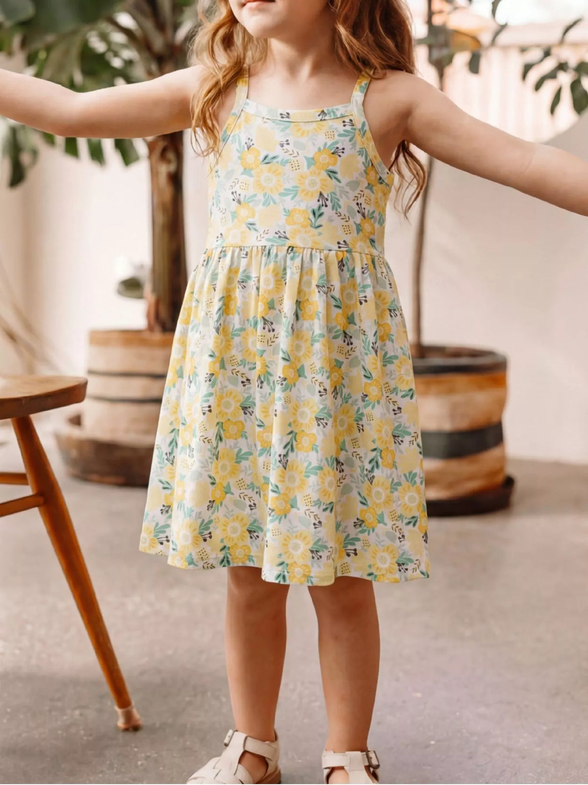 Yellow floral spaghetti-strap dress on a child