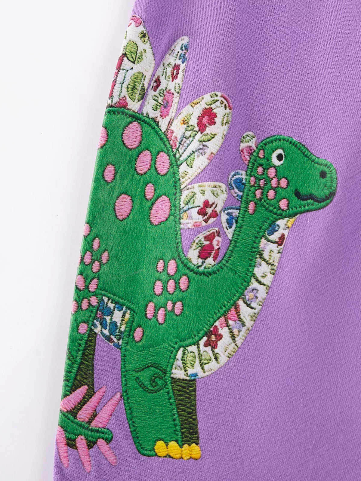 Green dinosaur applique with floral trim