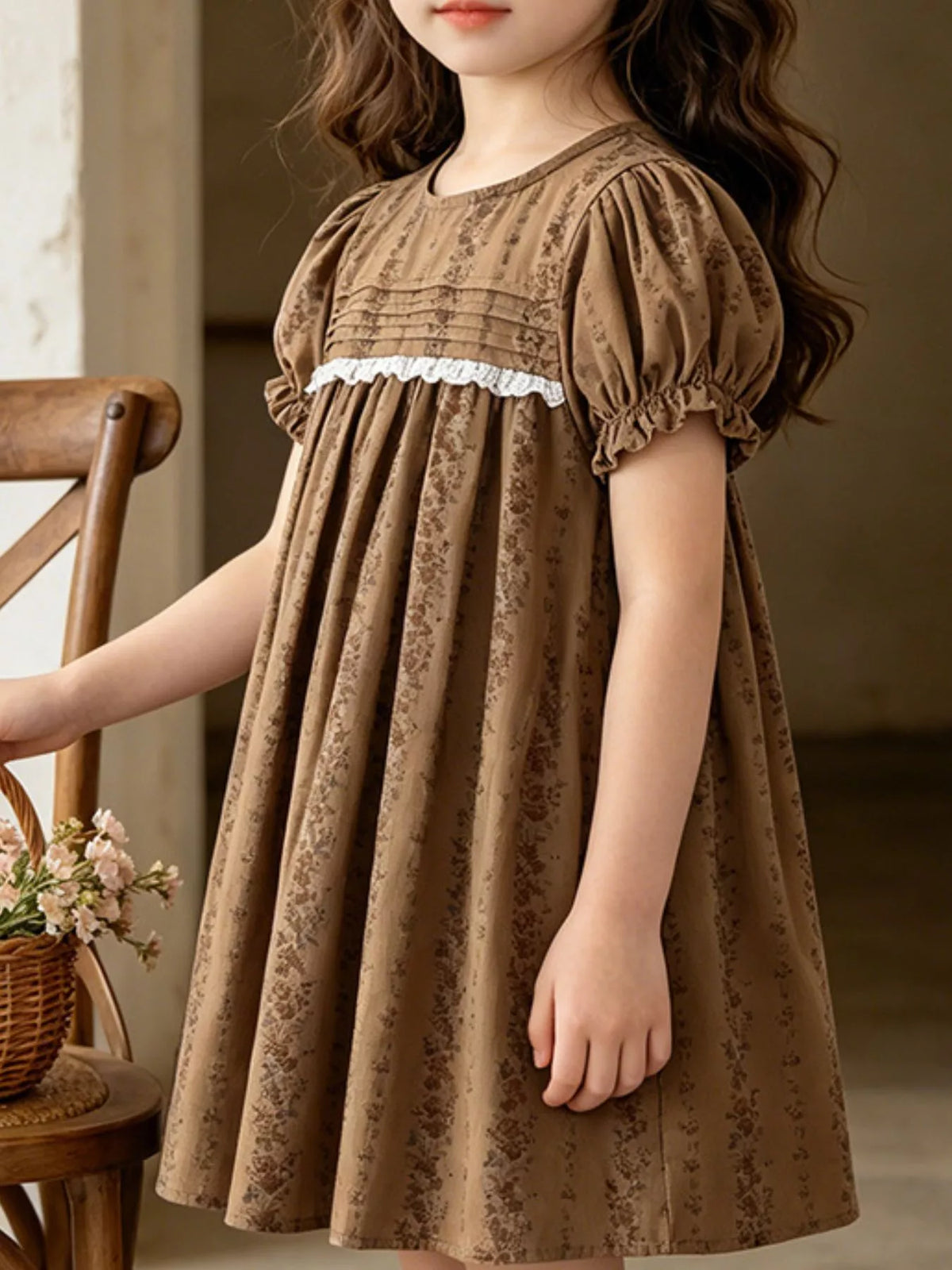 Brown floral puff-sleeve dress with lace trim on a child