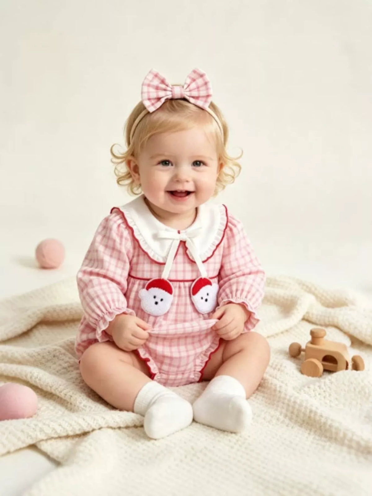 Front of the gingham outfit on a seated baby