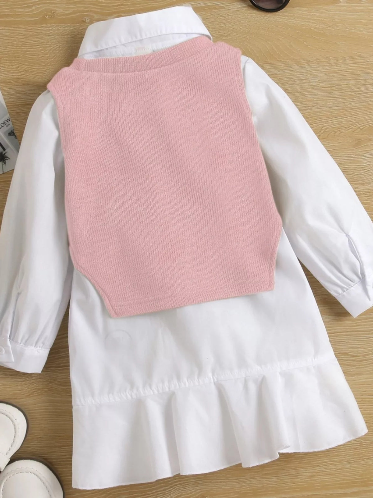 Back of the pink vest over the white shirt dress