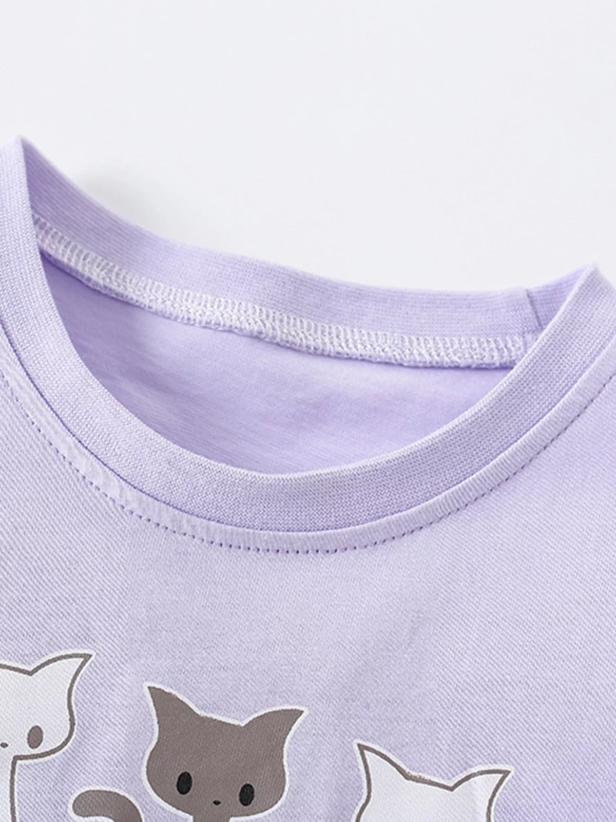 Lavender cat graphic pompom ruffle hem shirt — round neckline