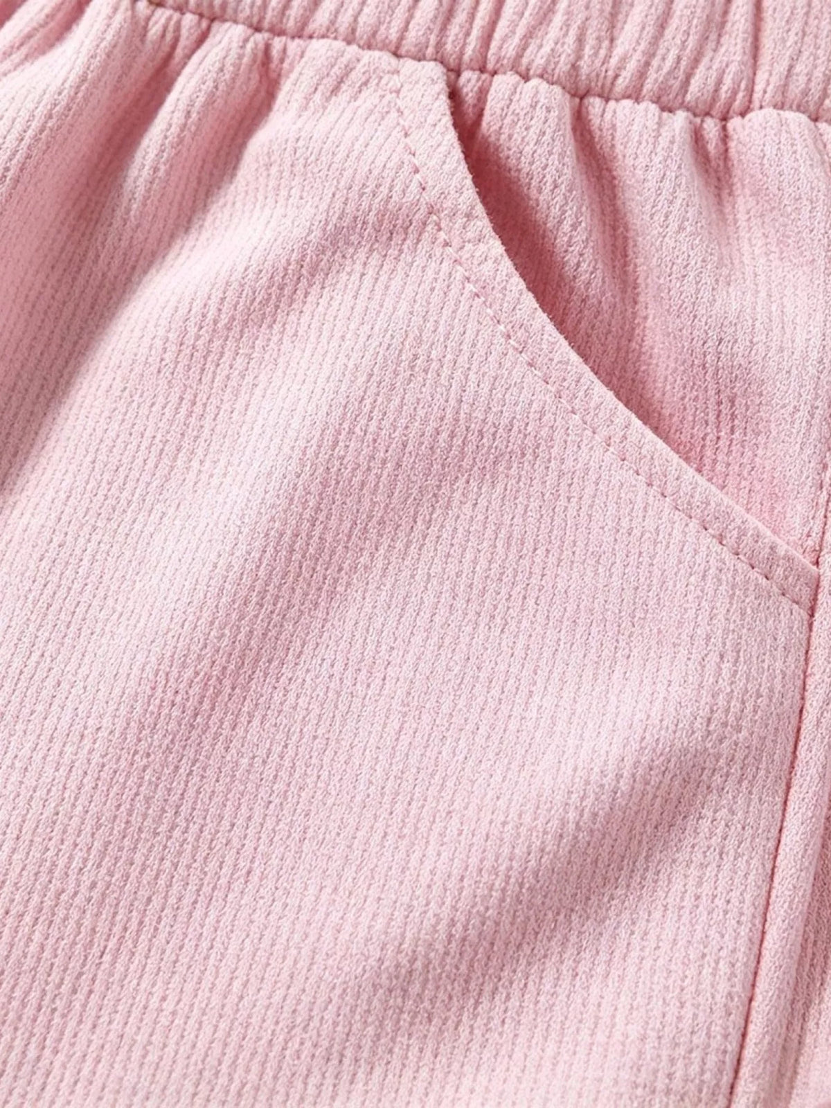 Elastic waistband on pink ribbed shorts
