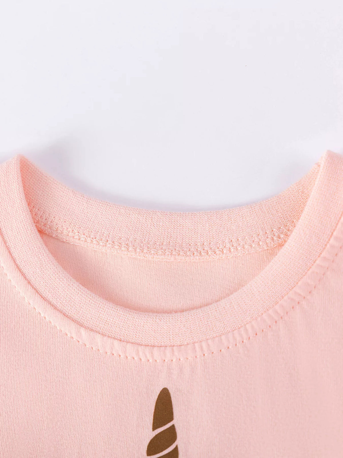 Peach round neckline and unicorn horn graphic
