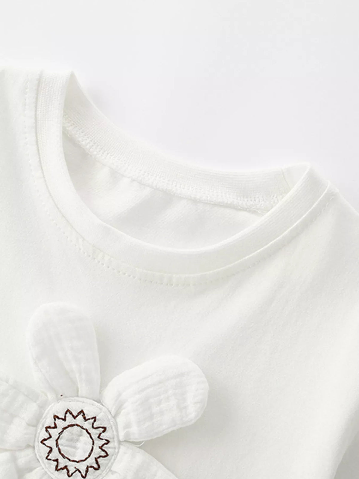 White dimensional flower applique shirt — round neckline