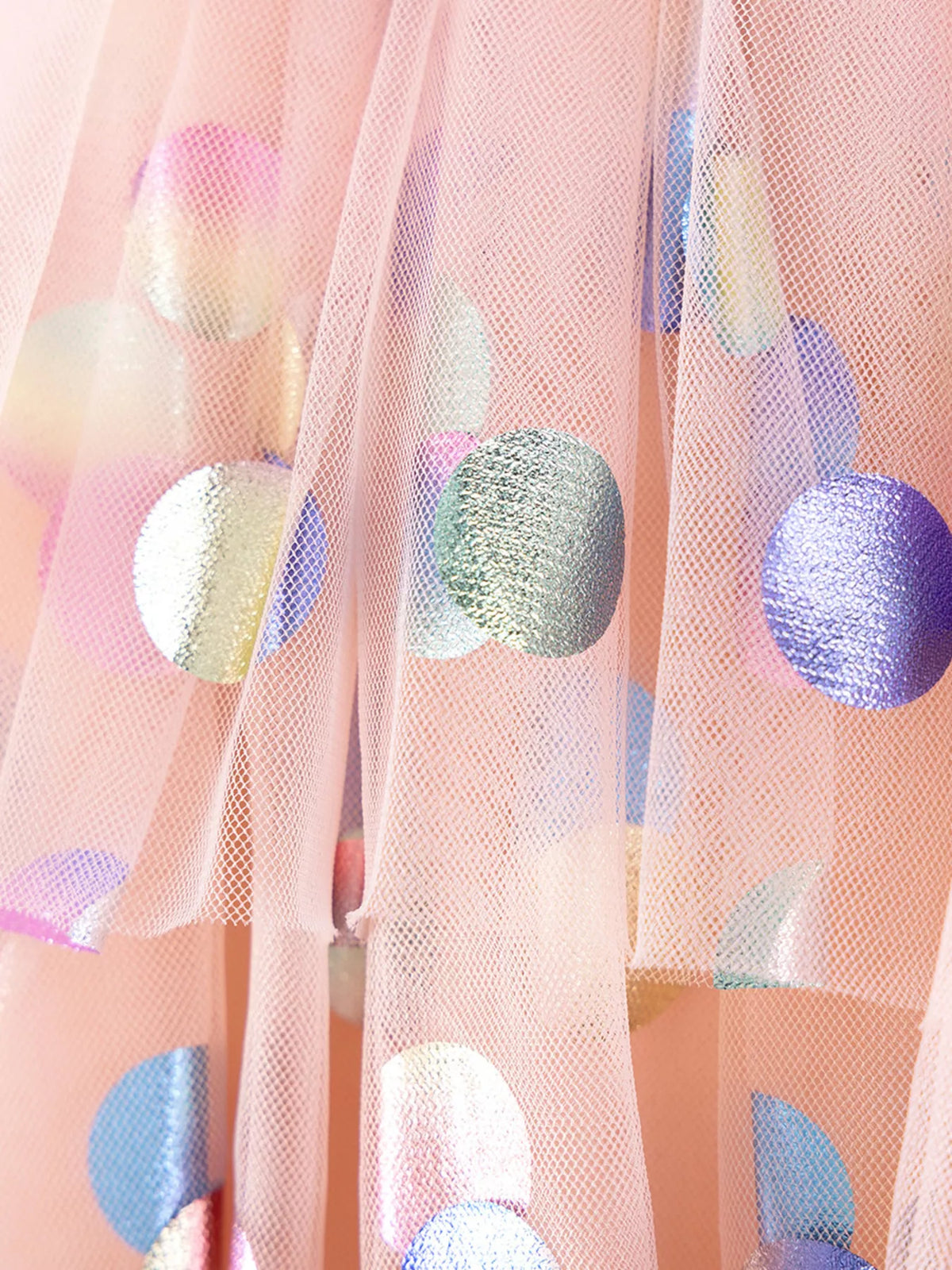 Large metallic circles on peach tulle