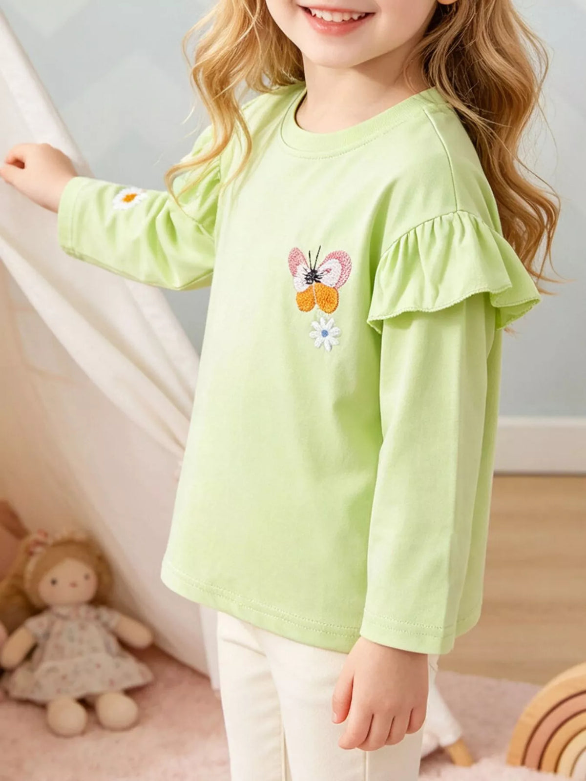 Lime green ruffle-shoulder long-sleeve butterfly top on a child
