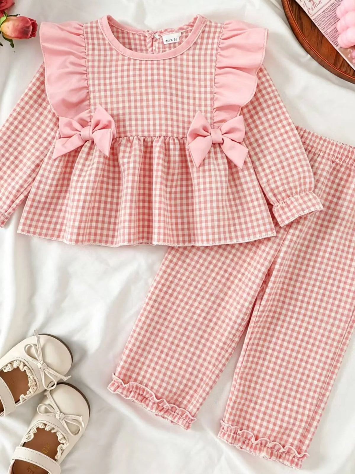 Pink gingham top and pants laid flat