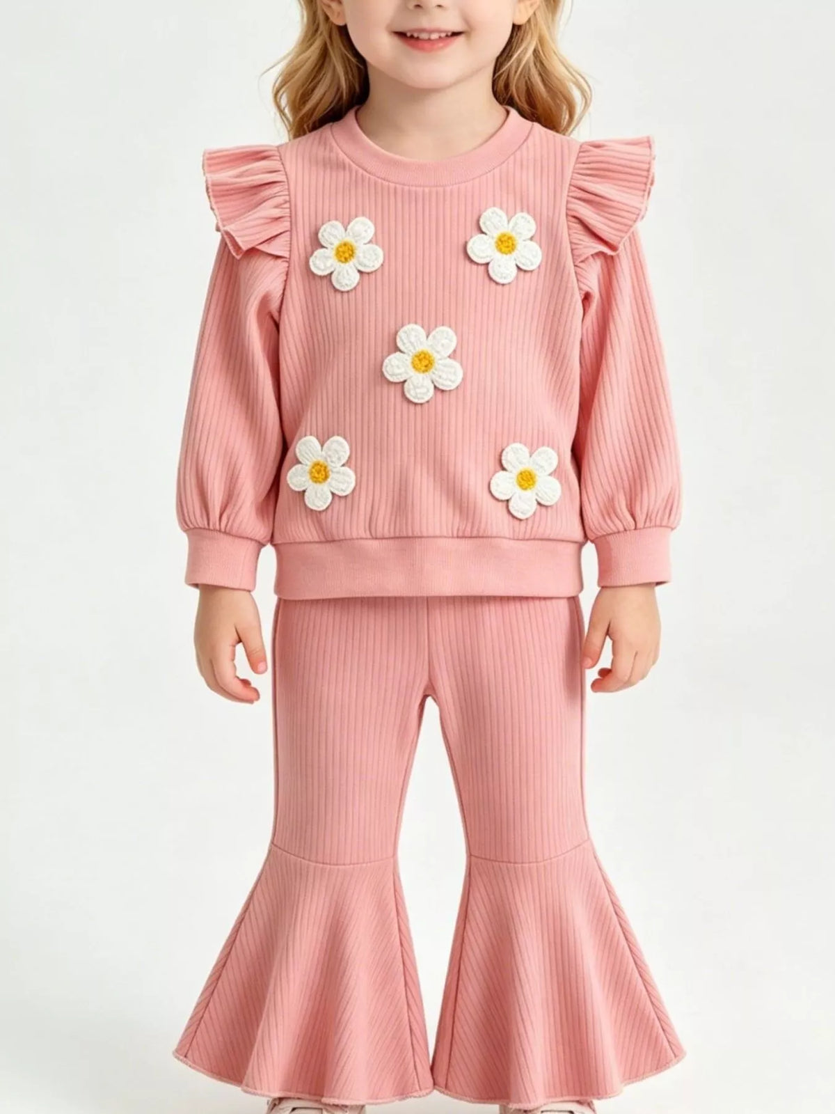 Pink ribbed daisy-applique ruffle top with flared pants on a child