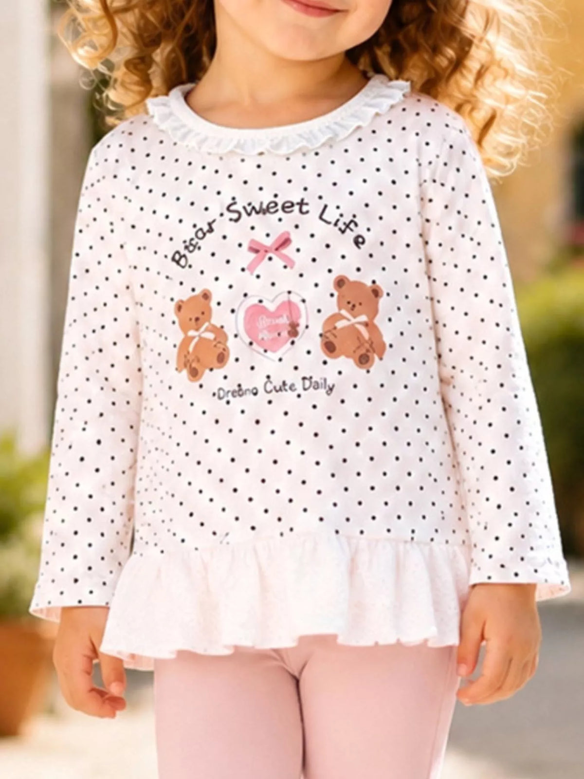 Bear graphic and ruffled white hem on a child