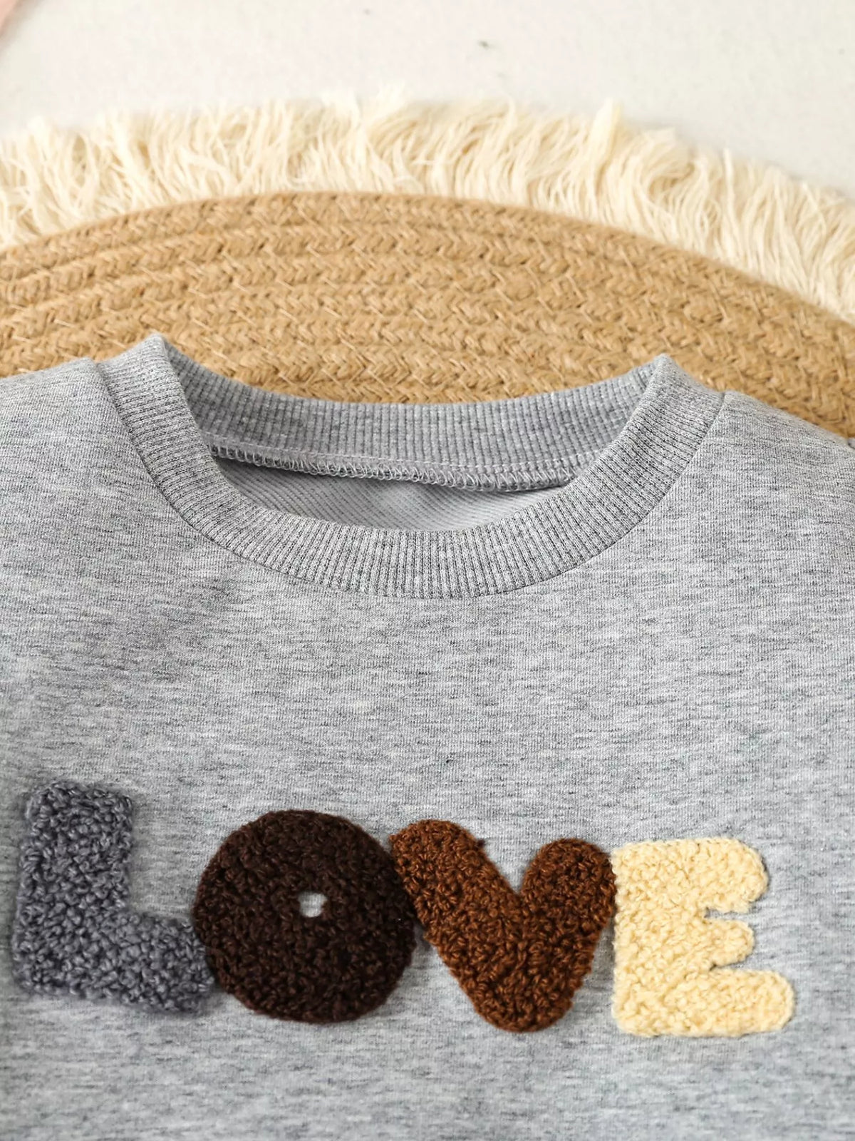 Gray round neckline and textured lettering