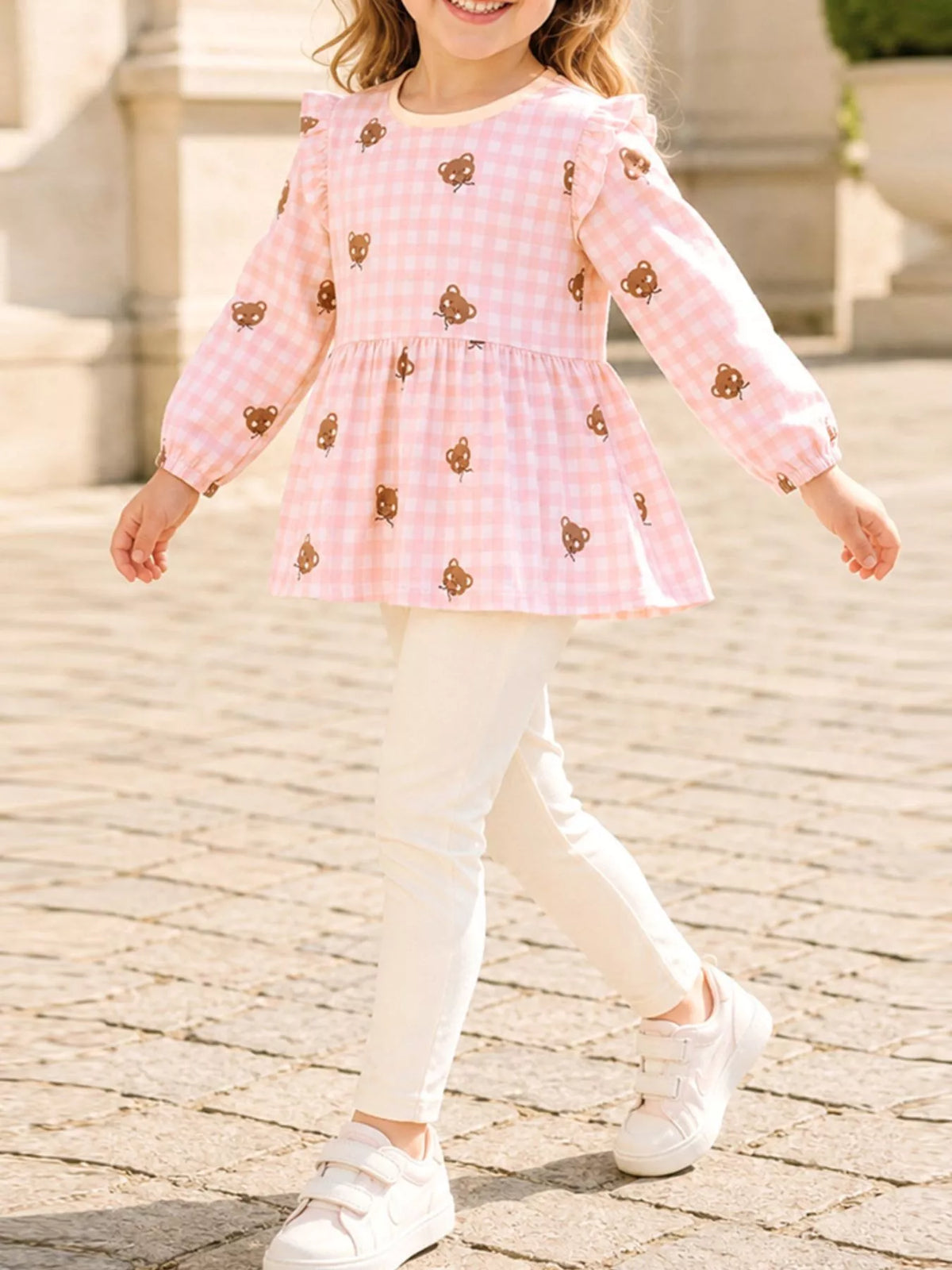 Pink gingham bear peplum top with cream leggings on a child