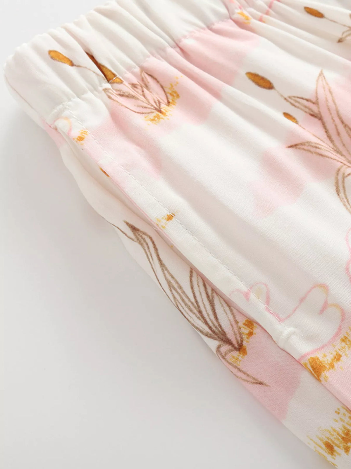 Gathered waistband and pale botanical print
