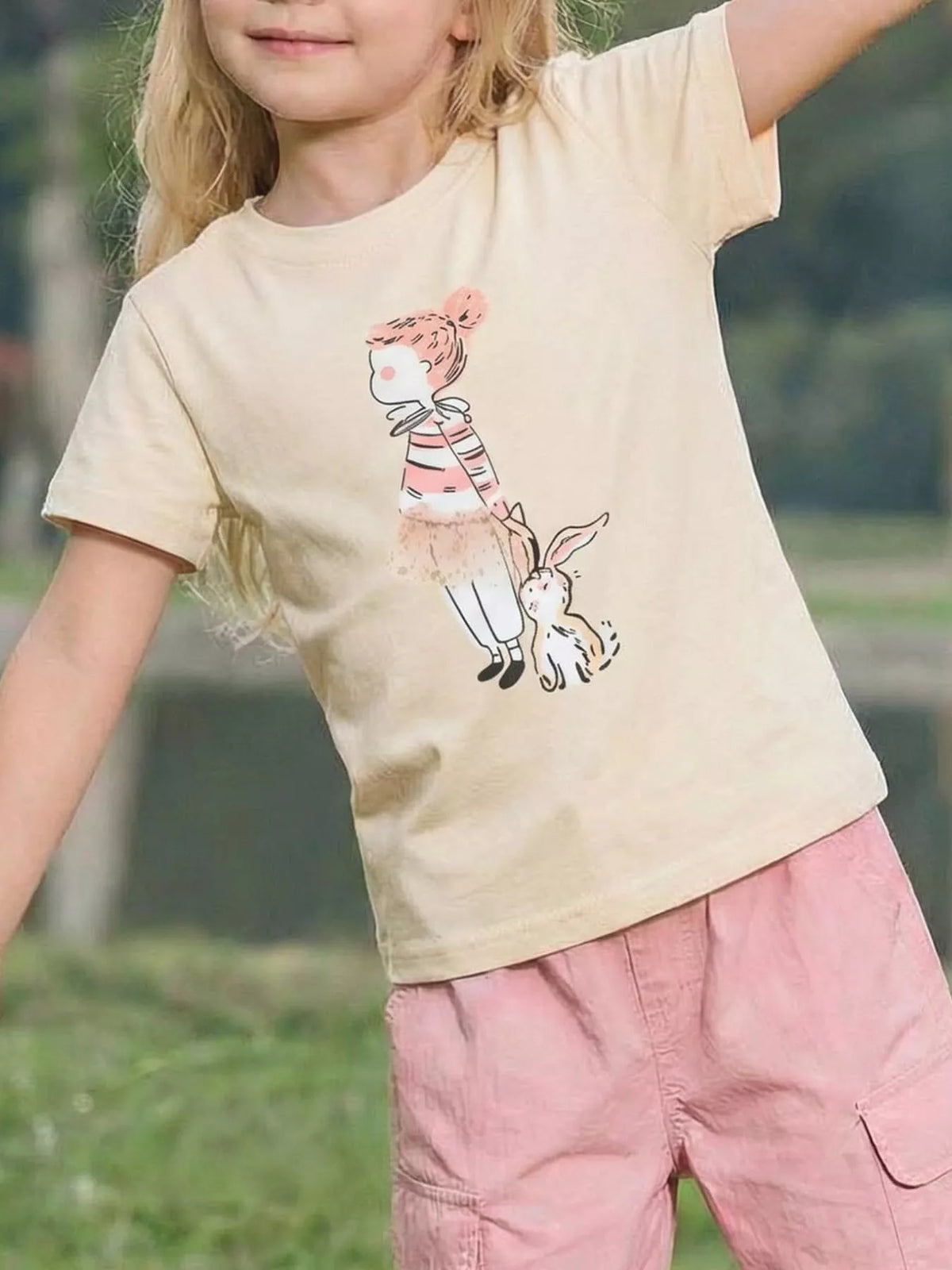 Cream tee with a girl-and-bunny graphic on a child