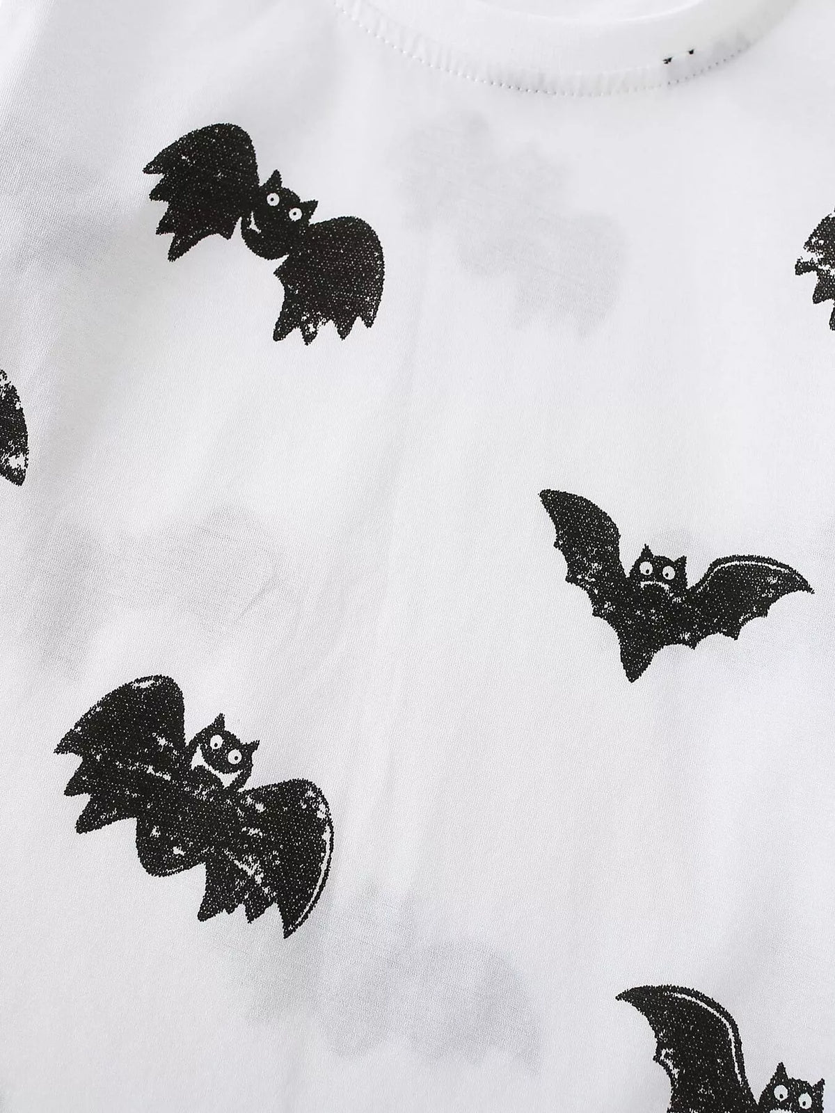 Black flying bats on white fabric