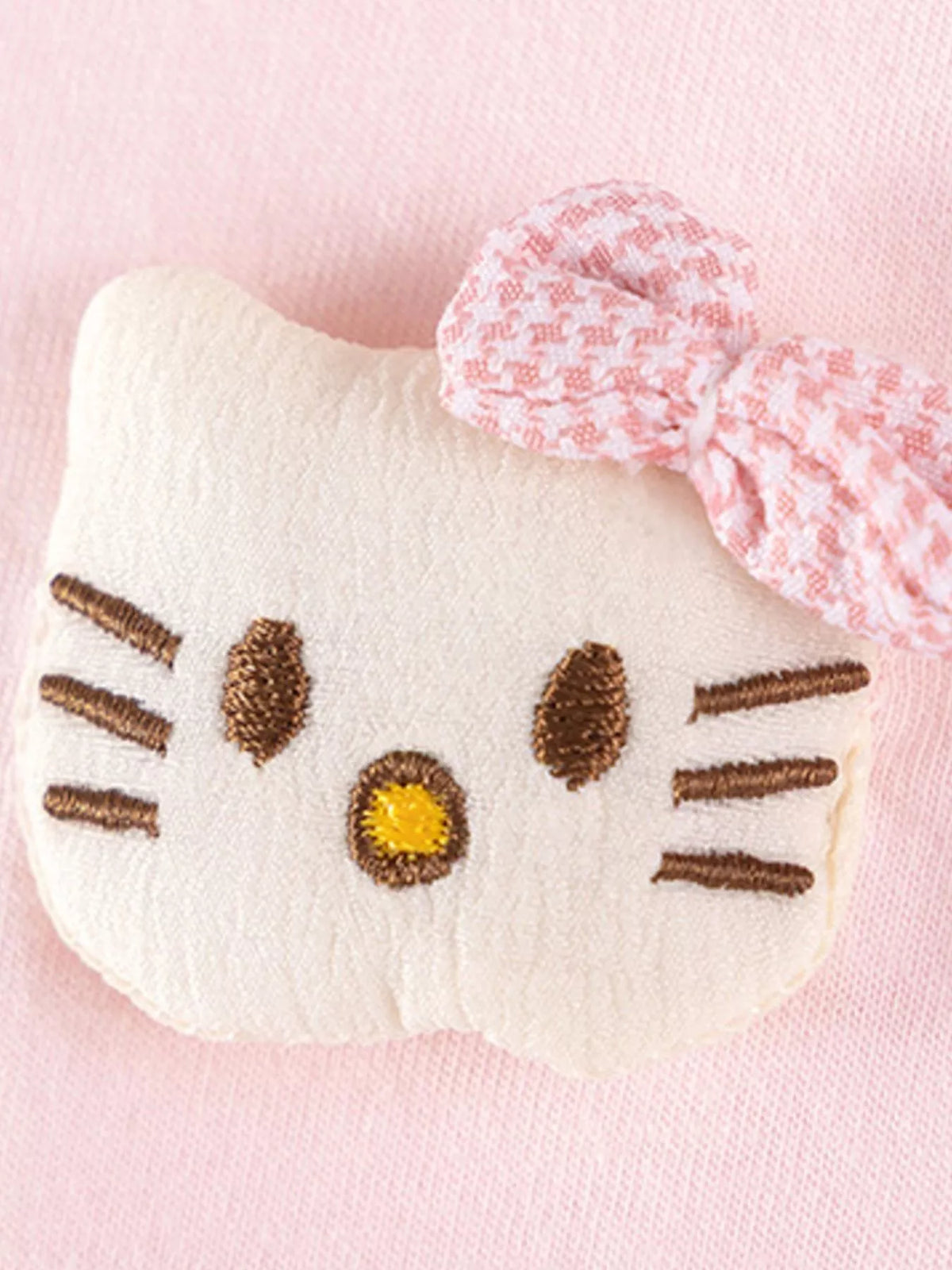 White cat-face applique with a pink checked bow