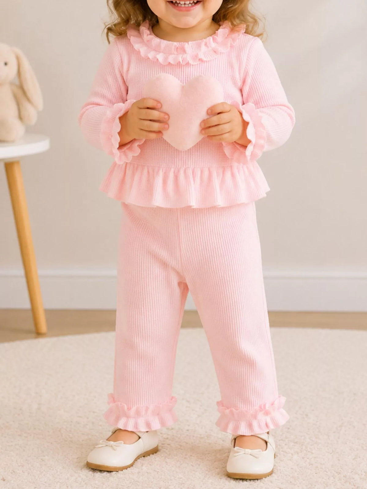 Pink outfit on a child holding a book
