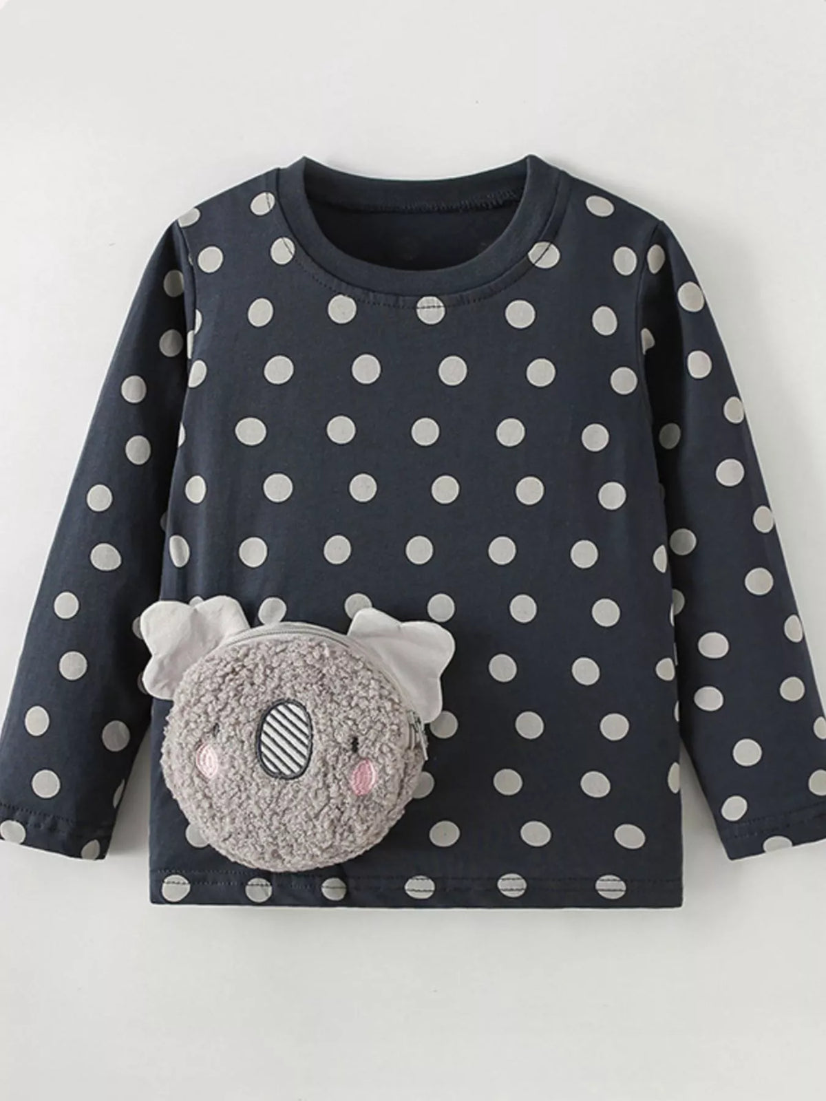 Black polka-dot long-sleeve top with a plush koala pocket laid flat