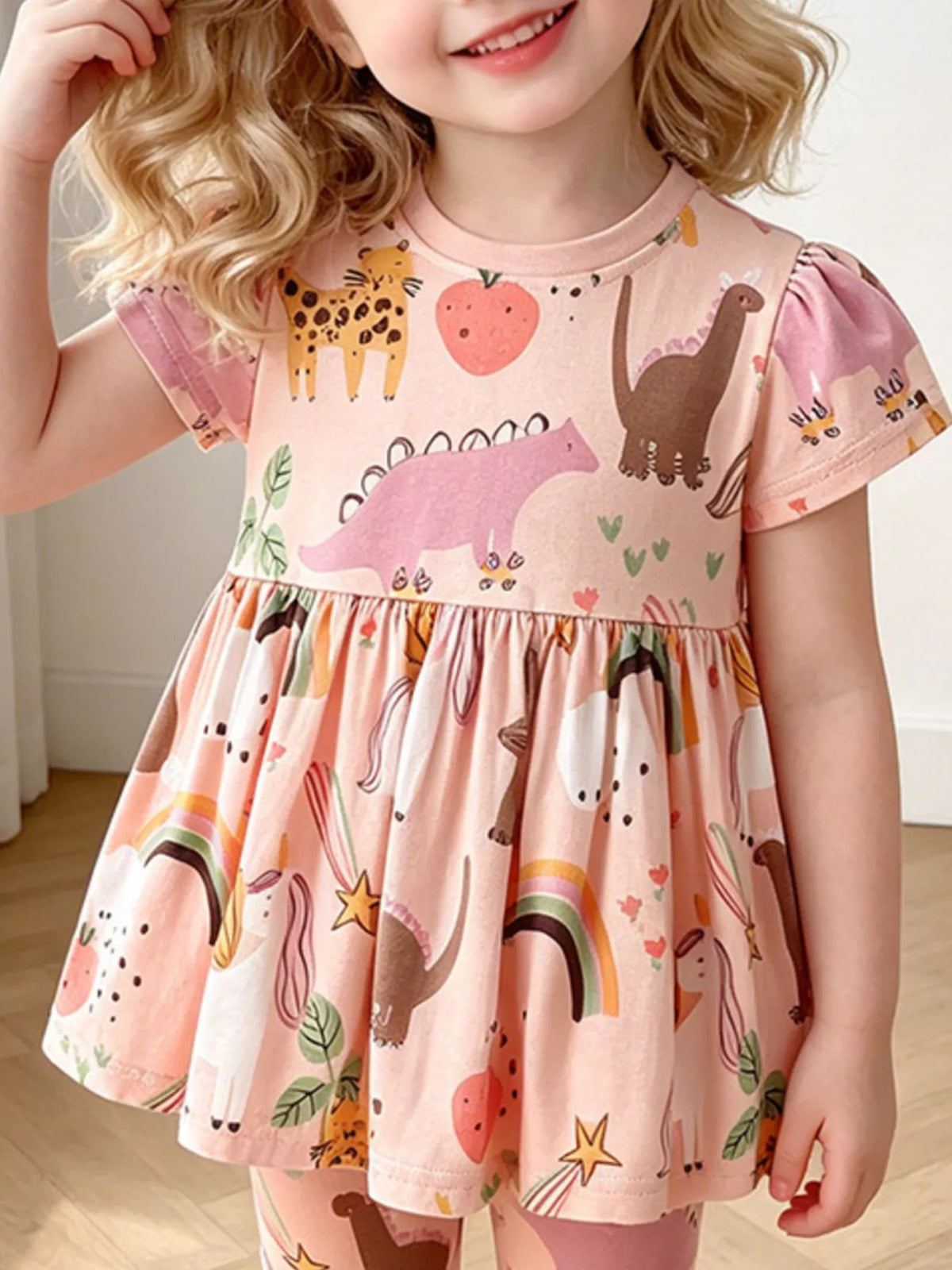 Peach dinosaur rainbow peplum top and leggings set — outfit shown on child