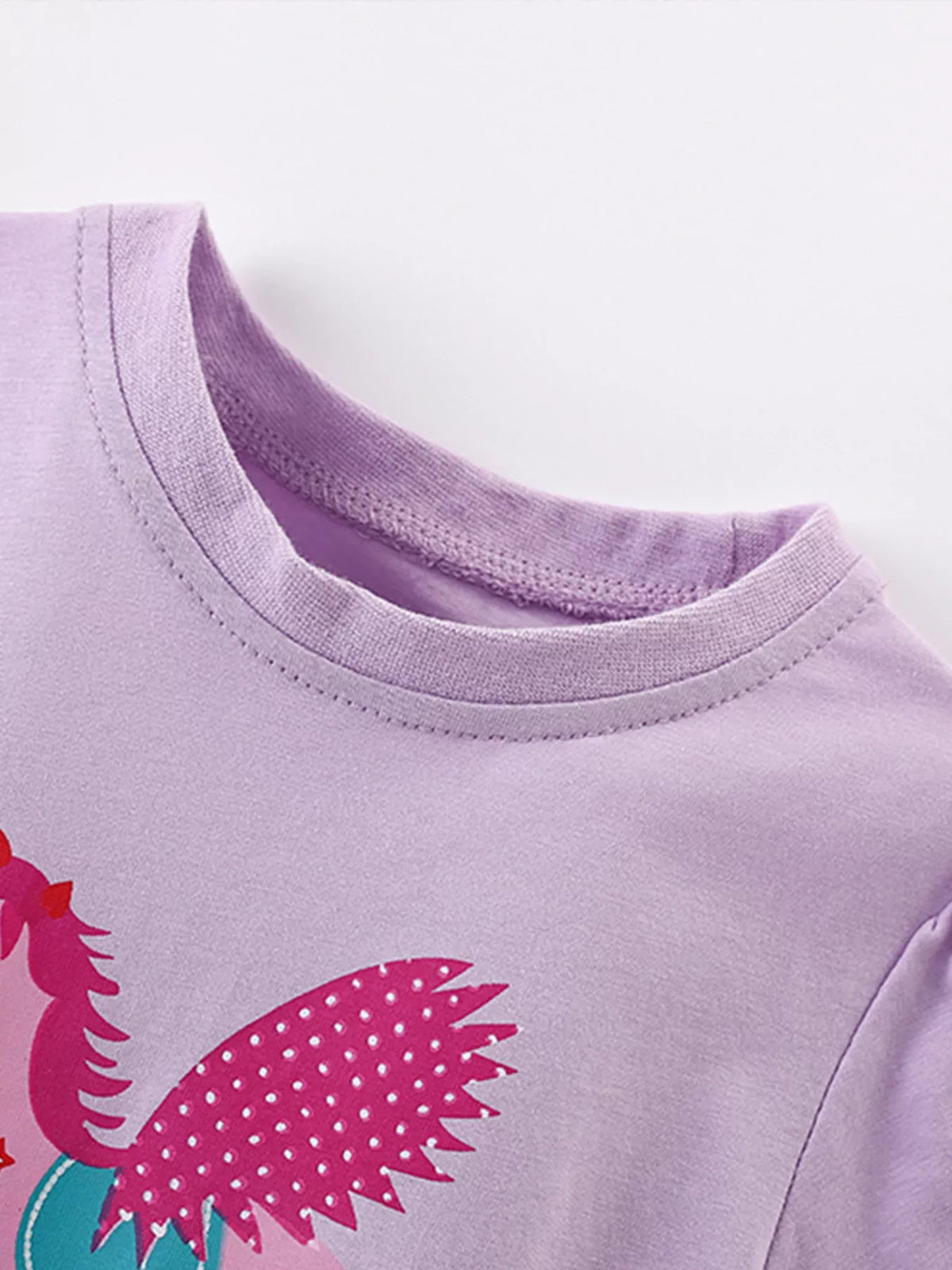 Lavender winged horse graphic ruffle hem shirt — round neckline