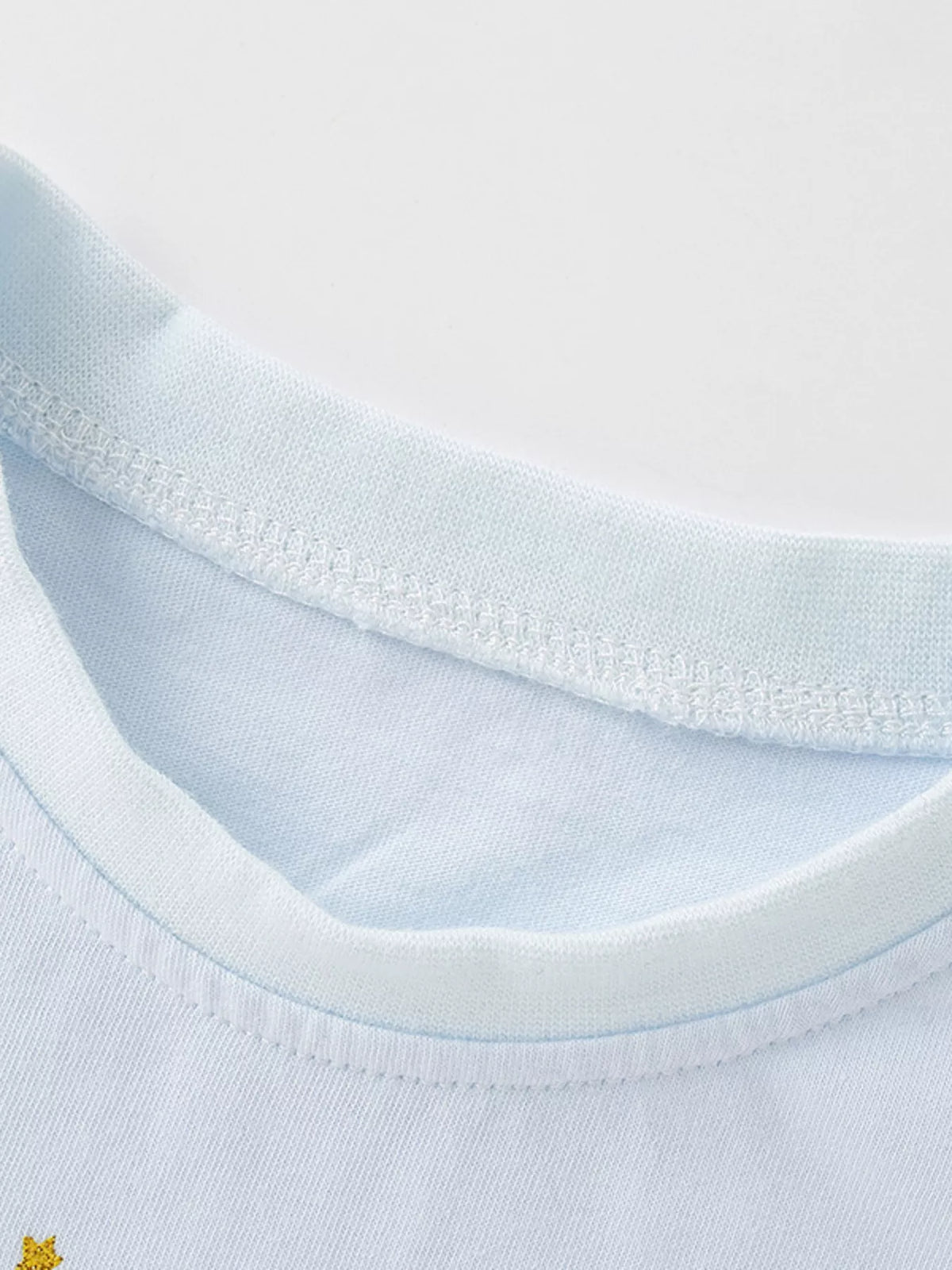 Light blue flower applique puff sleeve ruffle hem top — round neckline