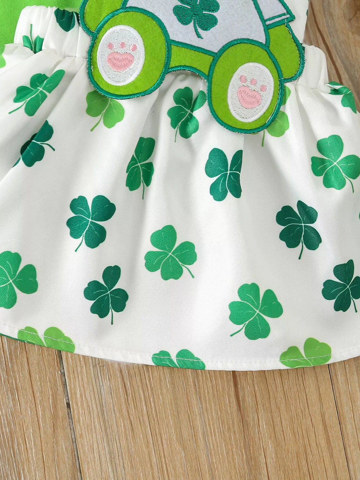 Green clover print on the white skirt