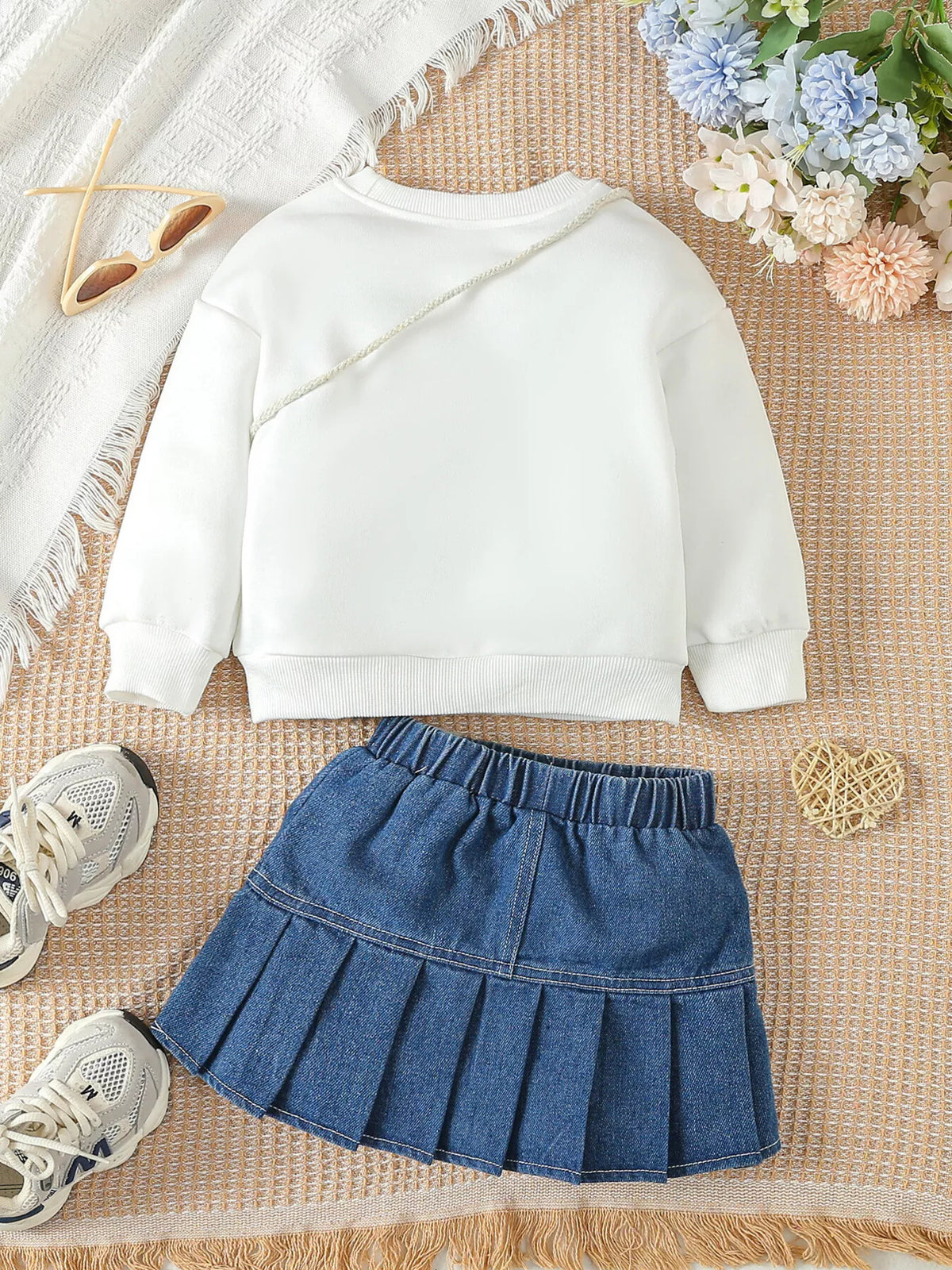 Back of the cream sweatshirt and denim skirt