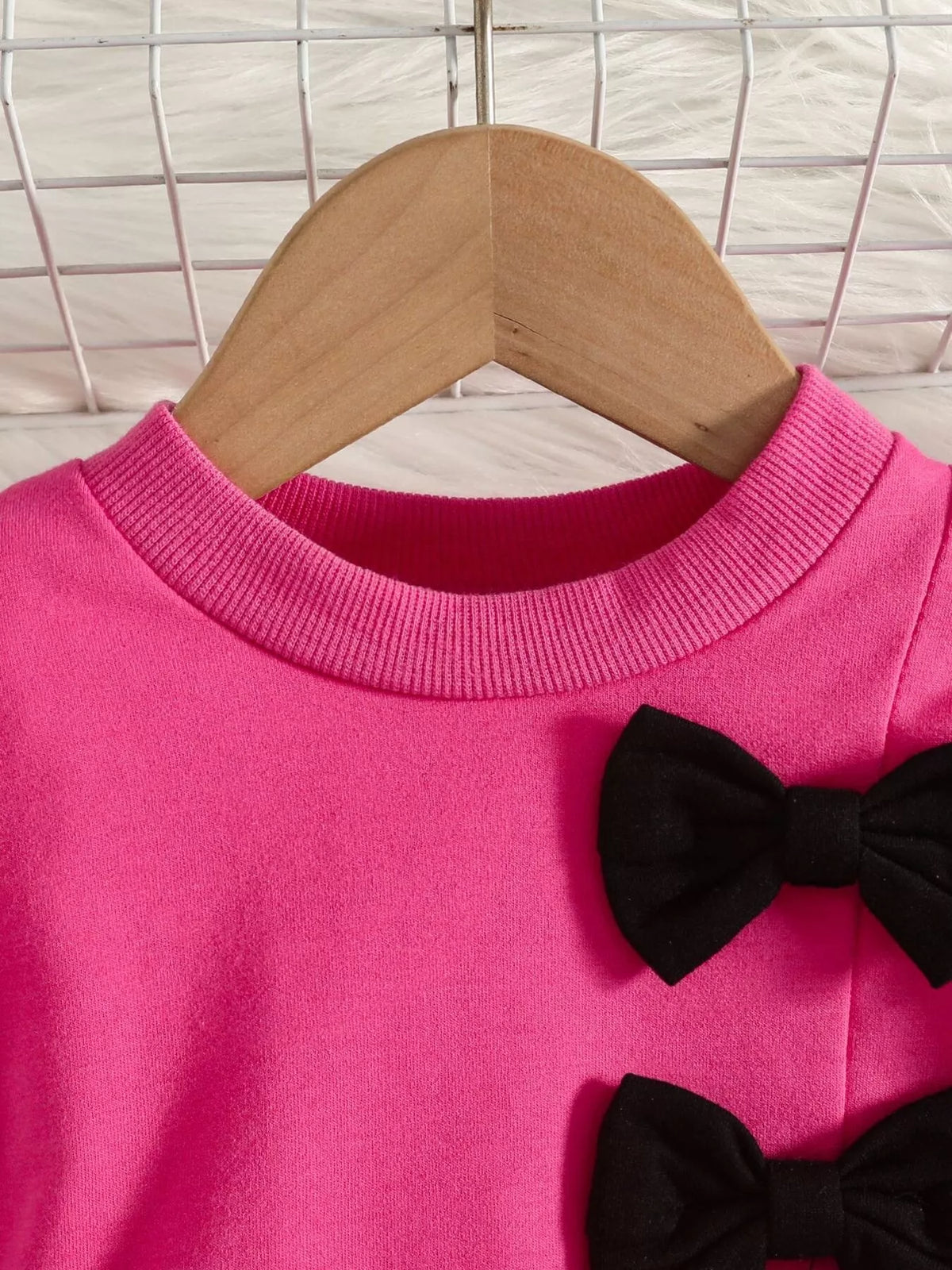 Bow embellished sweatshirt and black pants set — fuchsia neckline and black bows