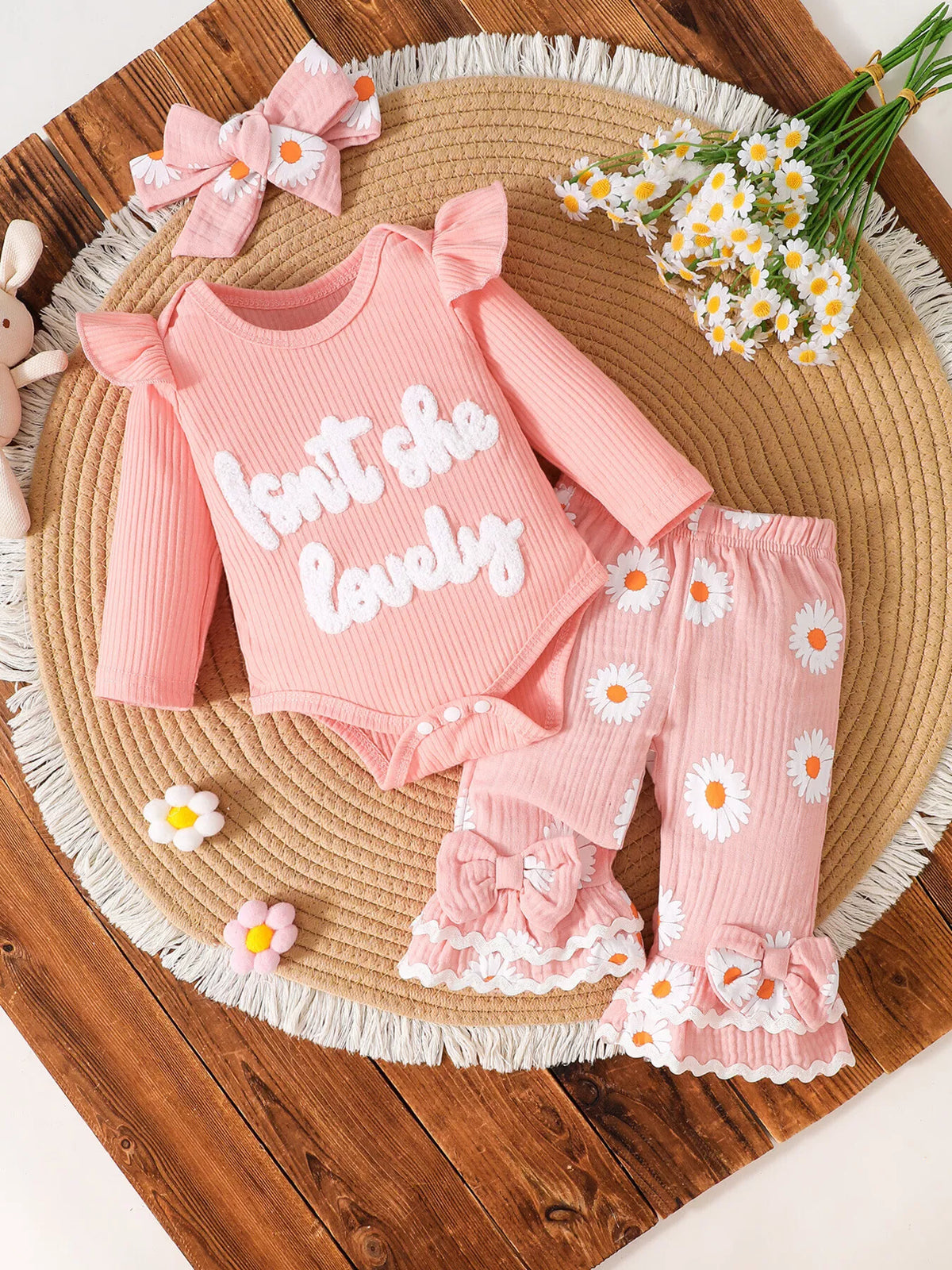 Outfit laid flat with floral pants and bow headband