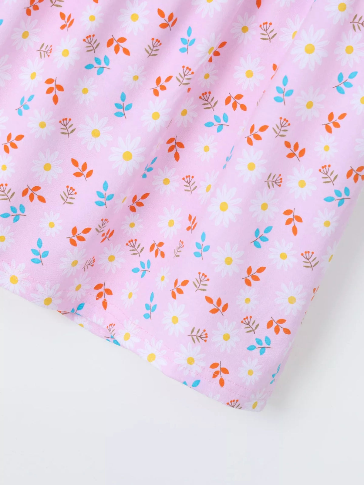 Small multicolored flowers on the pink skirt