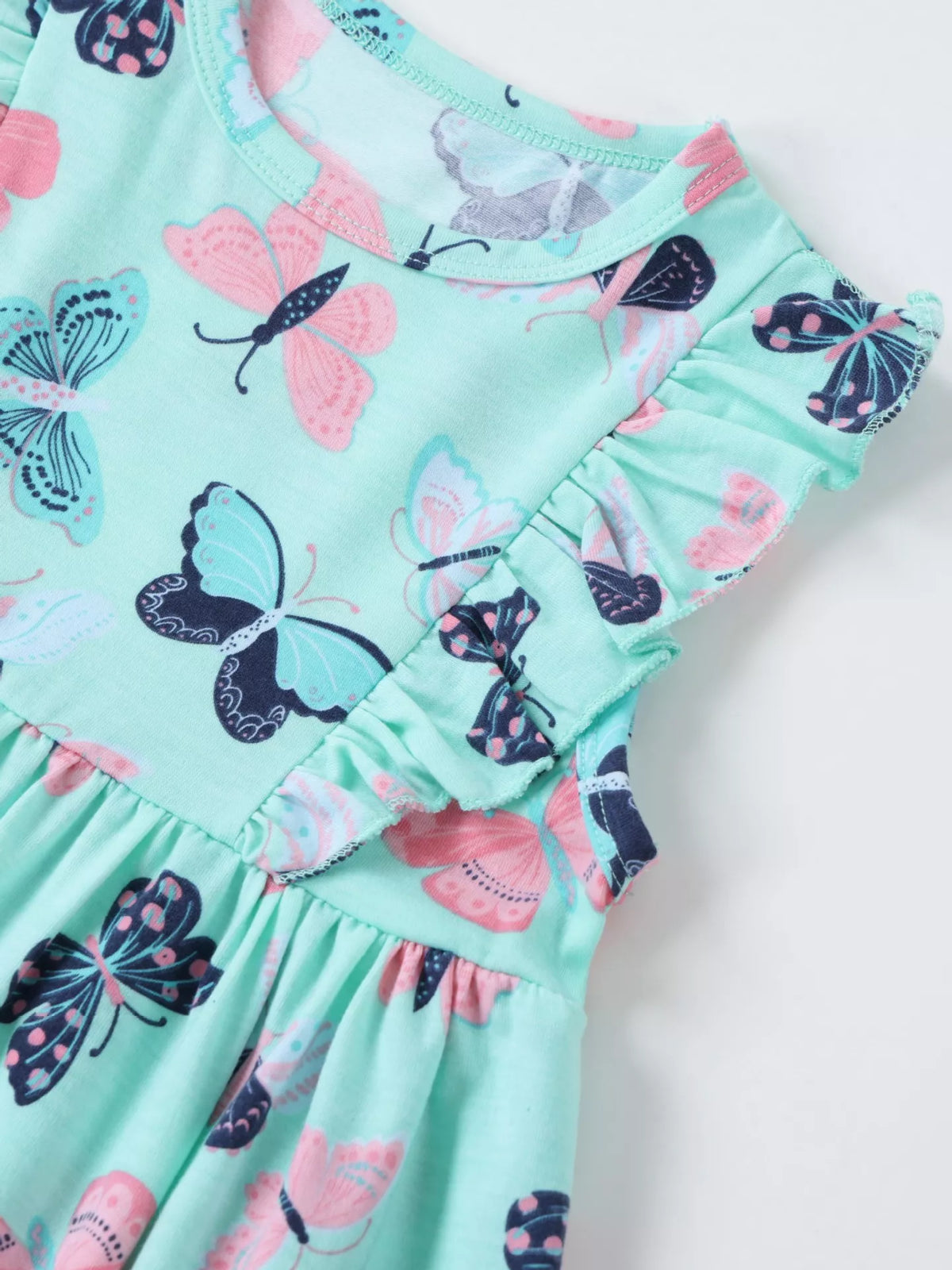 Round neckline and butterfly-print shoulder ruffle