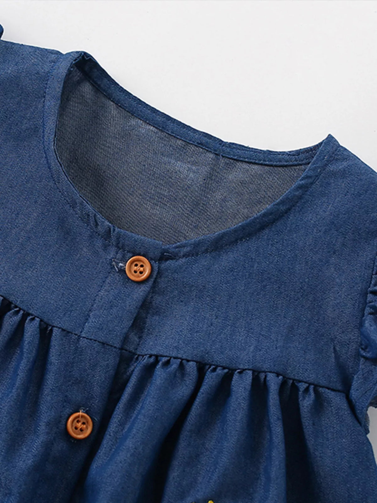 Dark Denim Dinosaur Embroidered Dress — buttoned neckline