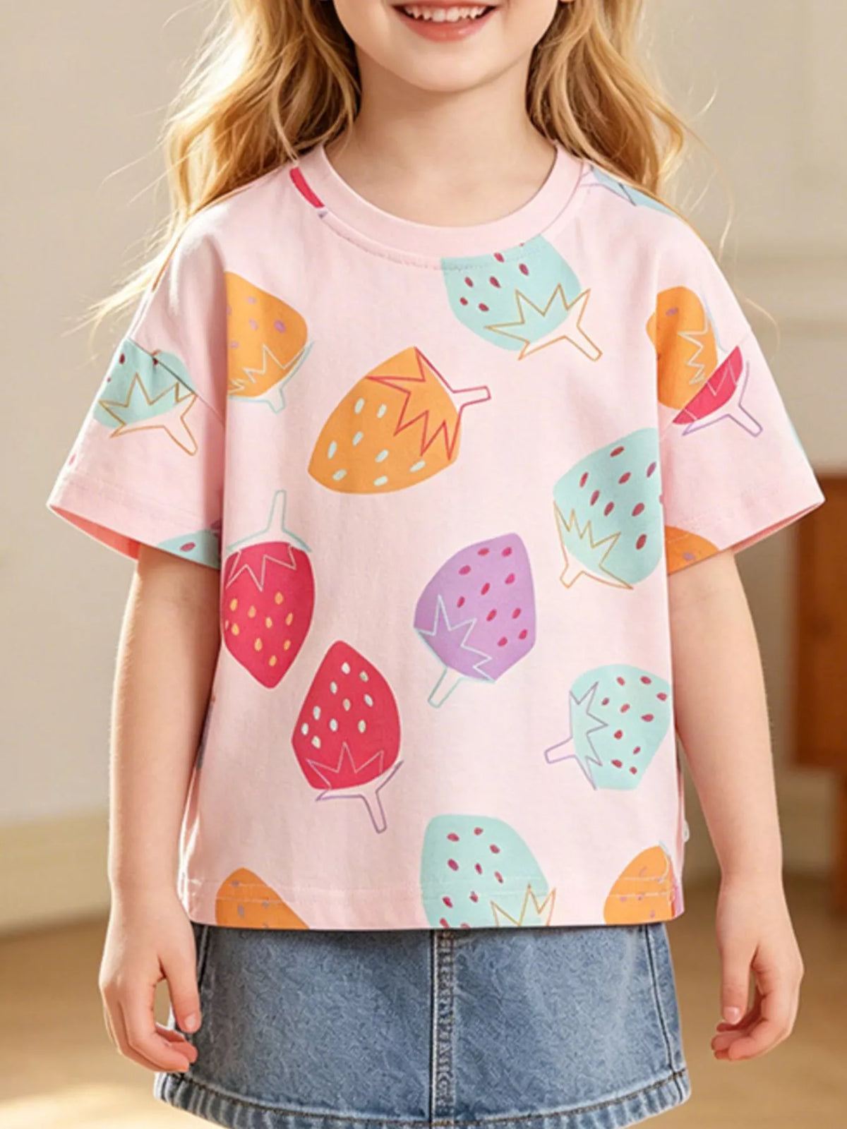 Pink multicolor strawberry print shirt — shirt shown on child
