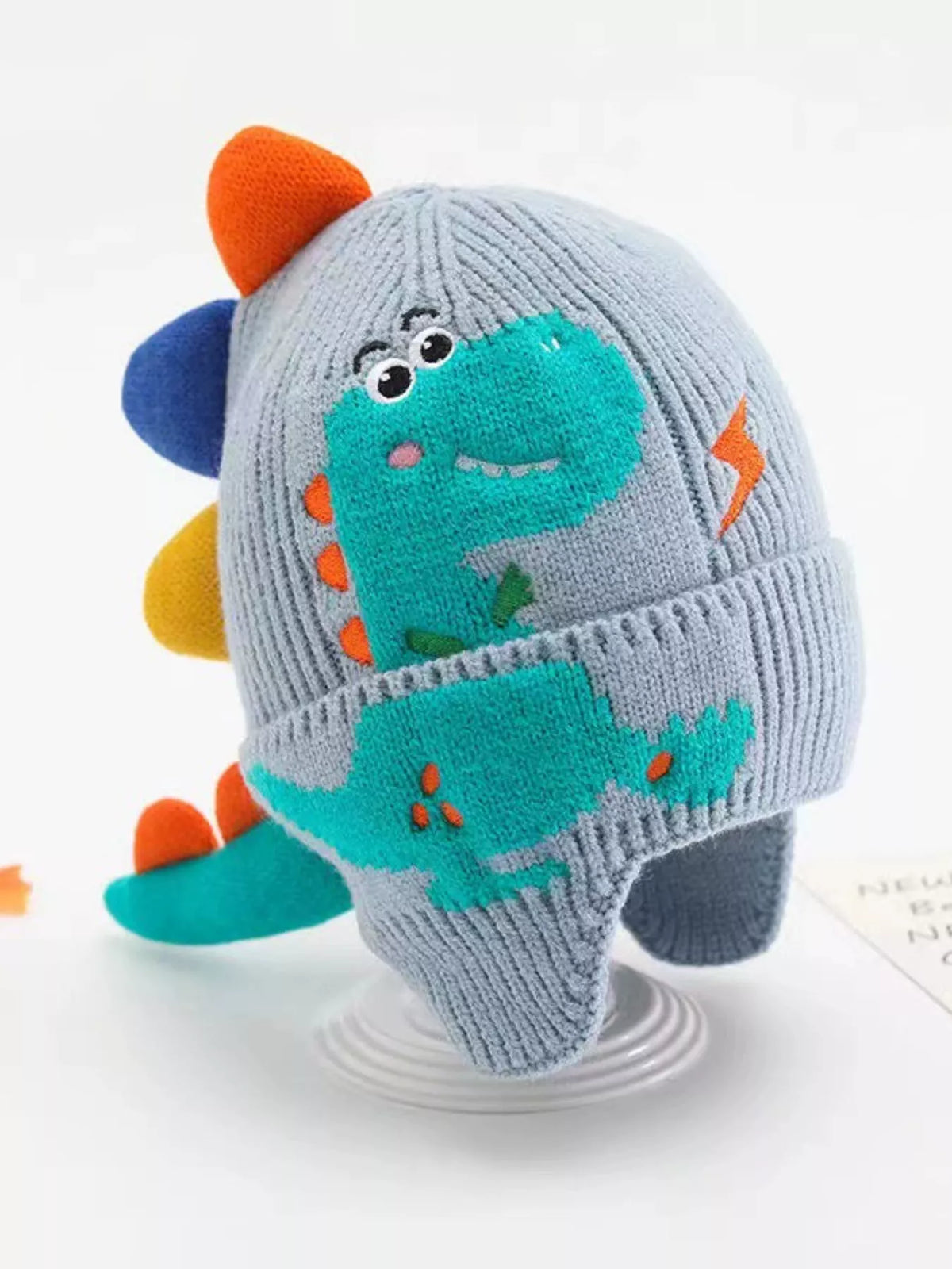 Dinosaur Knit Hat with Earflaps — blue hat side view
