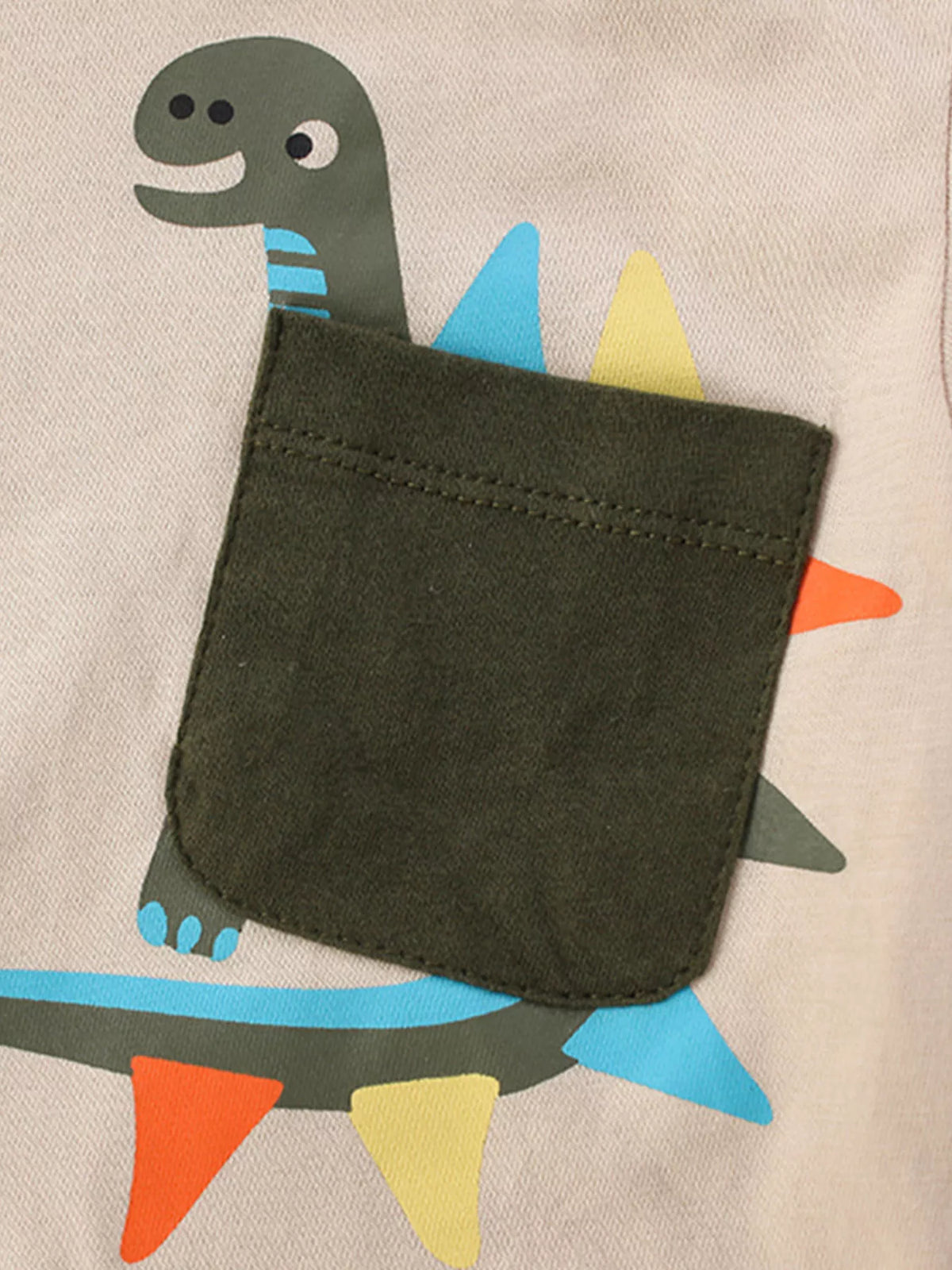 Beige dinosaur patch pocket shirt — green dinosaur pocket detail