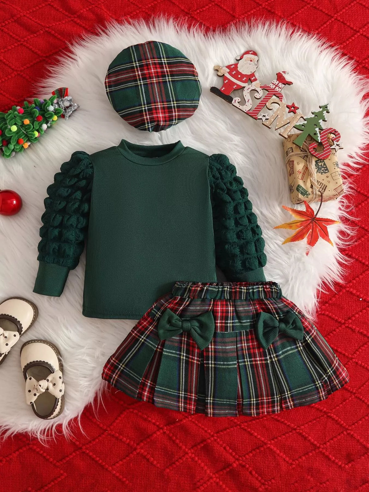 Green top with green plaid skirt and hat laid flat