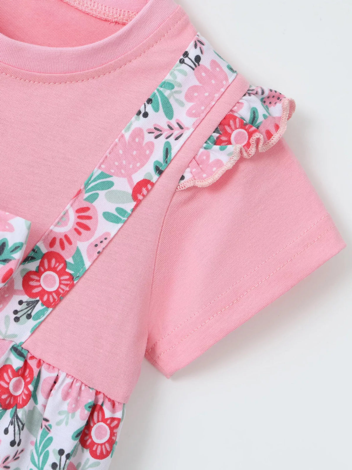 Floral shoulder trim beside the pink sleeve