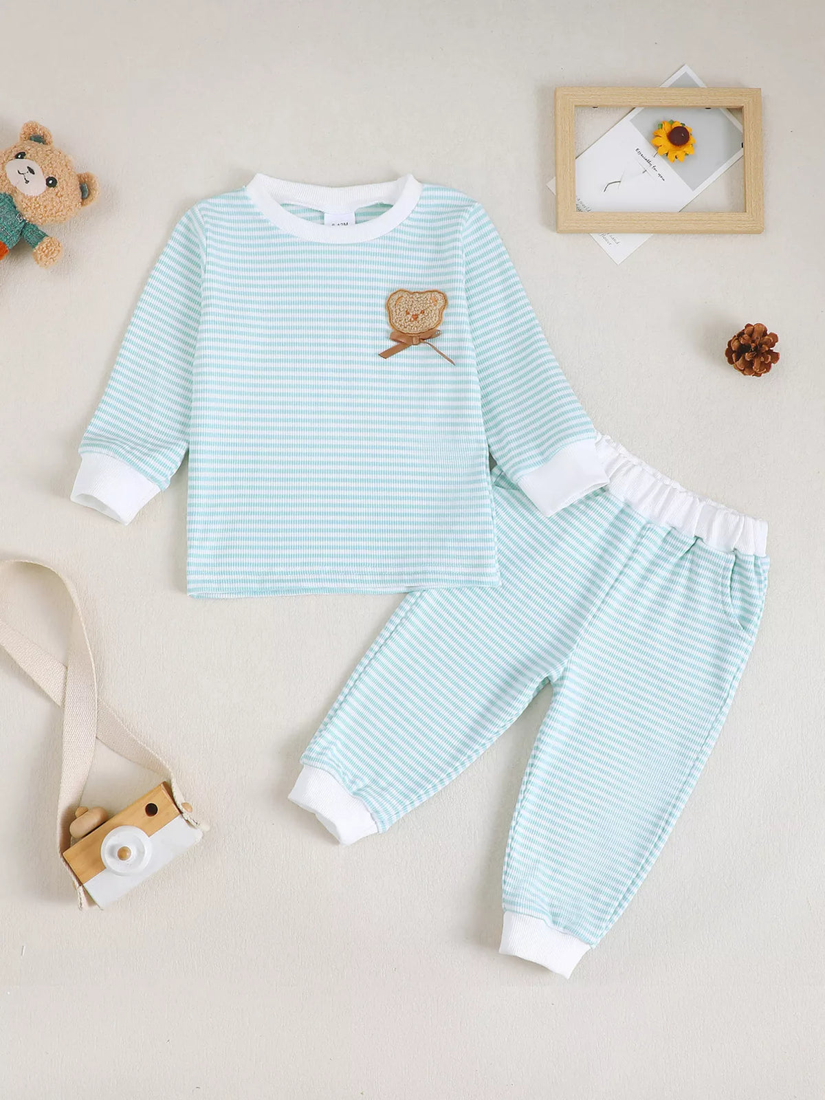 Pale blue striped top and pants laid flat