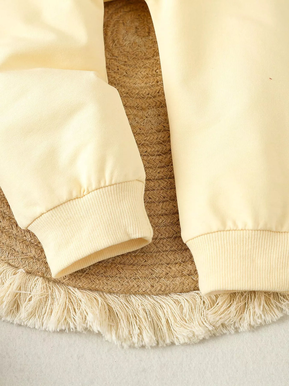 Pale yellow ribbed pant cuffs